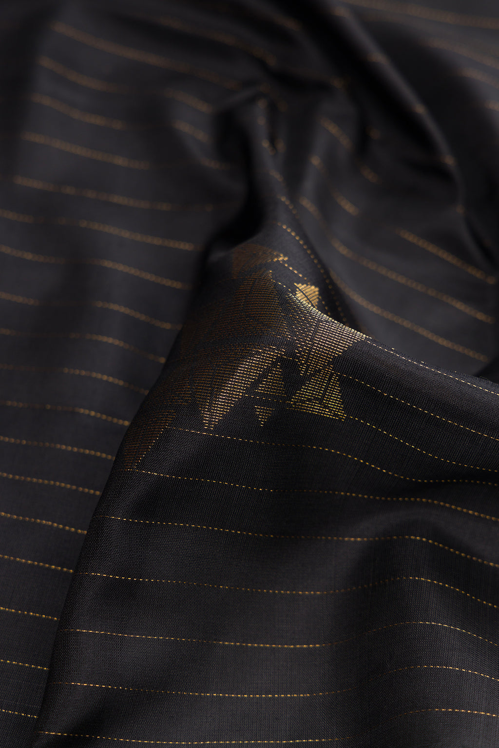 Close up of Black Dual Tone Soft Silk Saree with Stripes on the body and Zari Border.  displaying folds