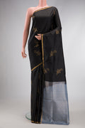 Black Dual Tone Soft Silk Saree with Stripes on the body and Zari Border.  displayed on a mannequin