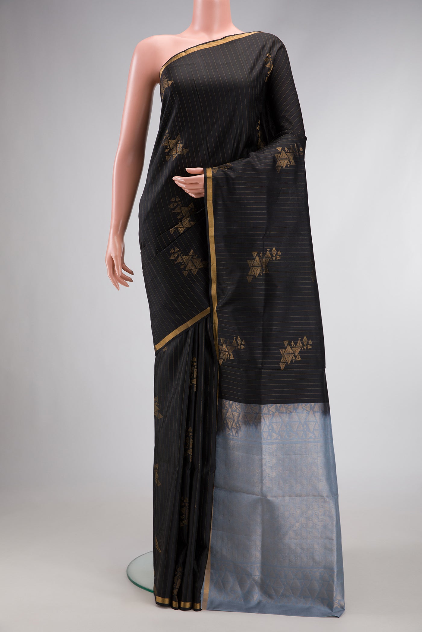 Black Dual Tone Soft Silk Saree with Stripes on the body and Zari Border.  displayed on a mannequin