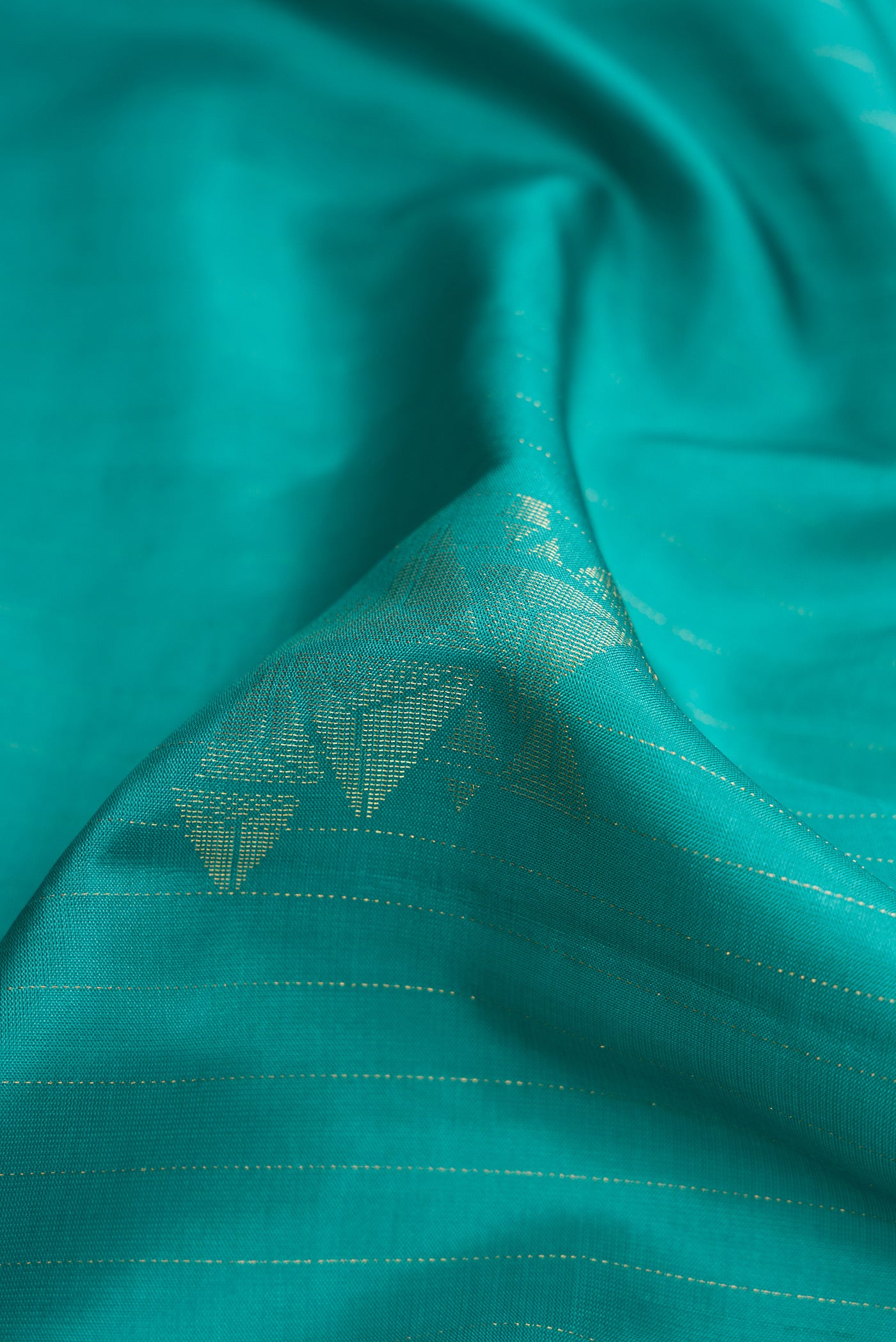 Close up of Maya Blue Dual Tone Soft Silk Saree with Zari Butta on the body and Without Border.  displaying folds