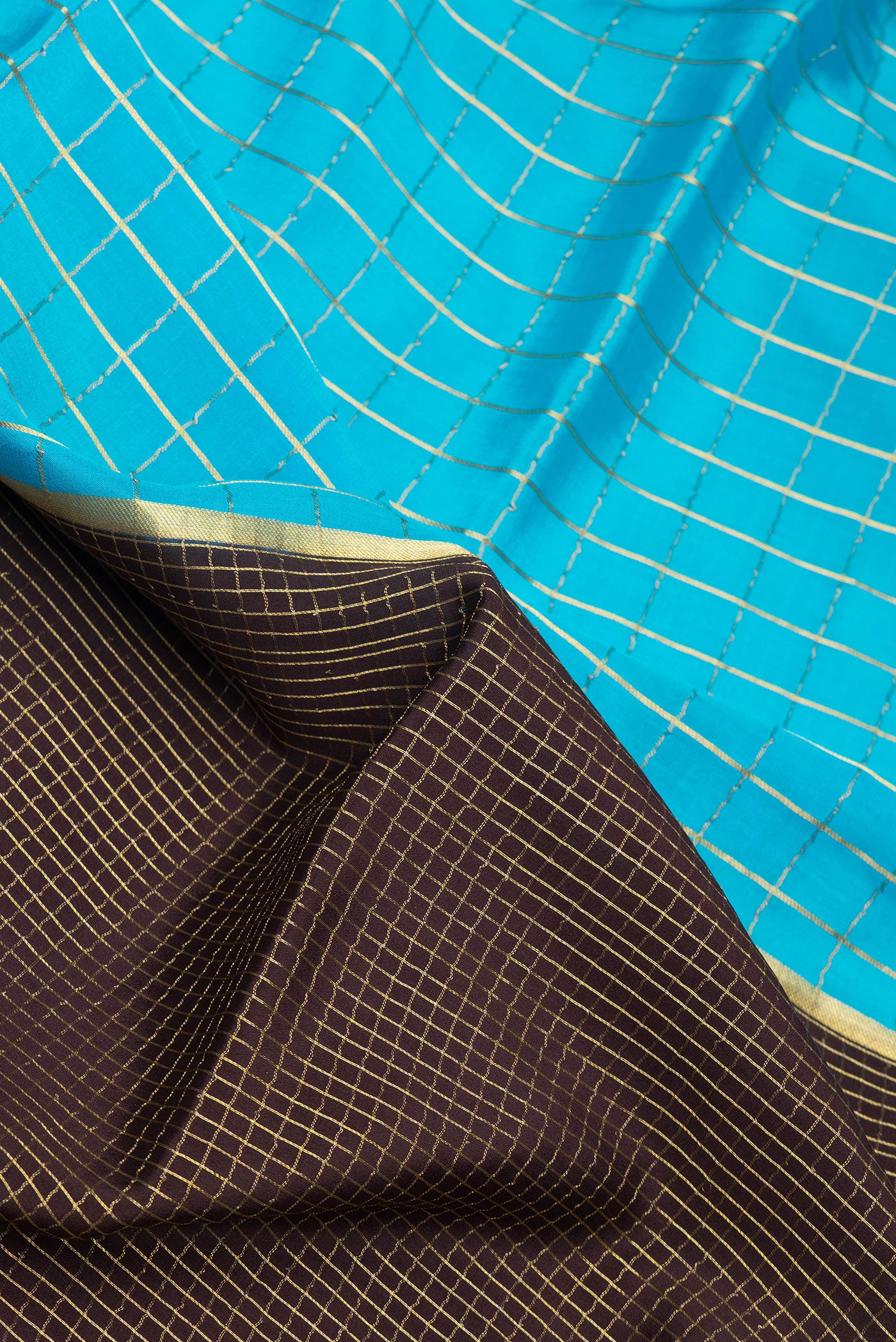 Close up of Sky Blue and Coffee Brown Color Mysore Silk Saree with Half And Half on the body and Zari Border.  displaying folds