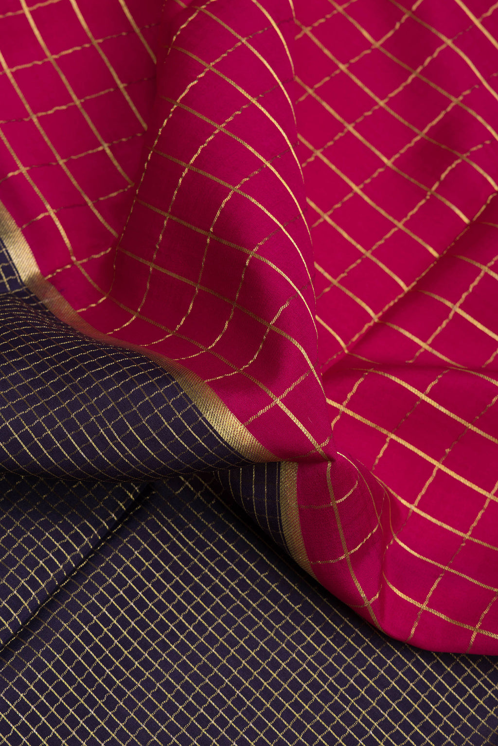 Close up of Multi Color Mysore Silk Saree with Checked design on the body and Zari Border.  displaying folds