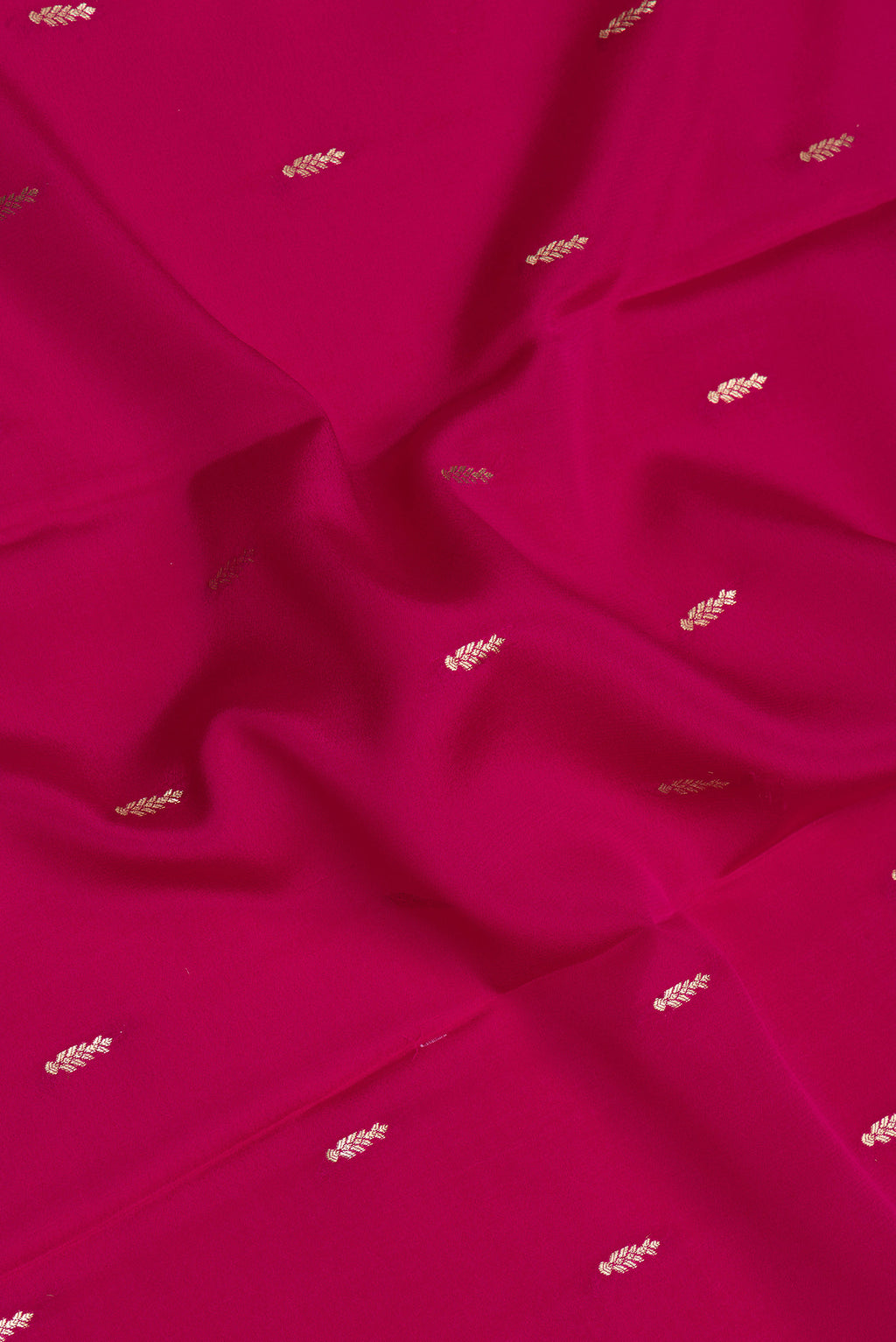 Close up of Dark Pink Mysore Silk Saree with Zari Butta on the body and Zari Border.  displaying folds