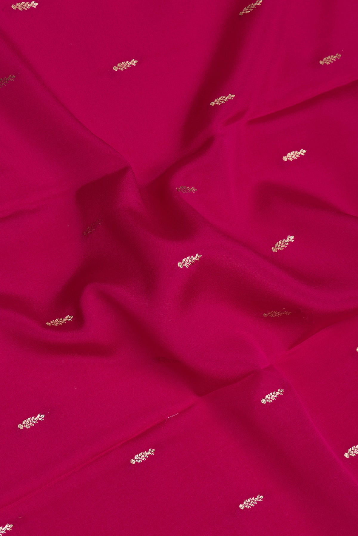 Close up of Dark Pink Mysore Silk Saree with Zari Butta on the body and Zari Border.  displaying folds