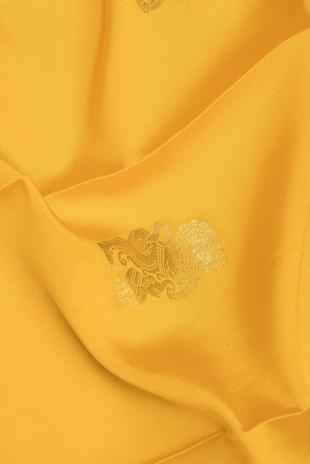 Close up of Yellow Mysore Crepe Saree with Zari Butta on the body and Fancy Border.  displaying folds