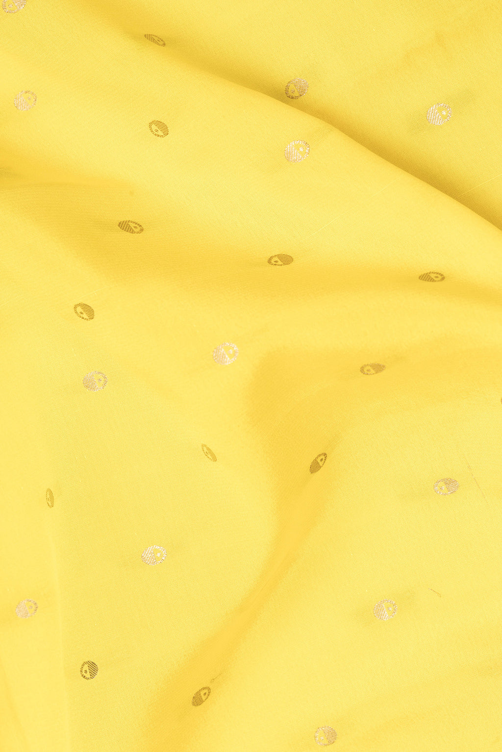 Close up of Lemon Yellow Mysore Crepe Saree with Zari Butta on the body and Zari Border.  displaying folds