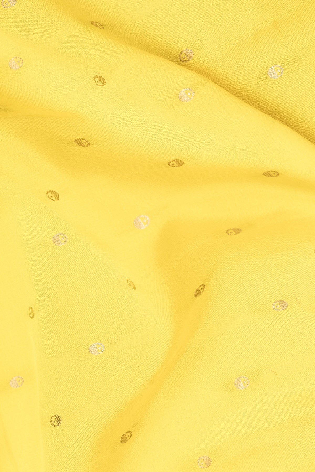 Close up of Lemon Yellow Mysore Crepe Saree with Zari Butta on the body and Zari Border.  displaying folds