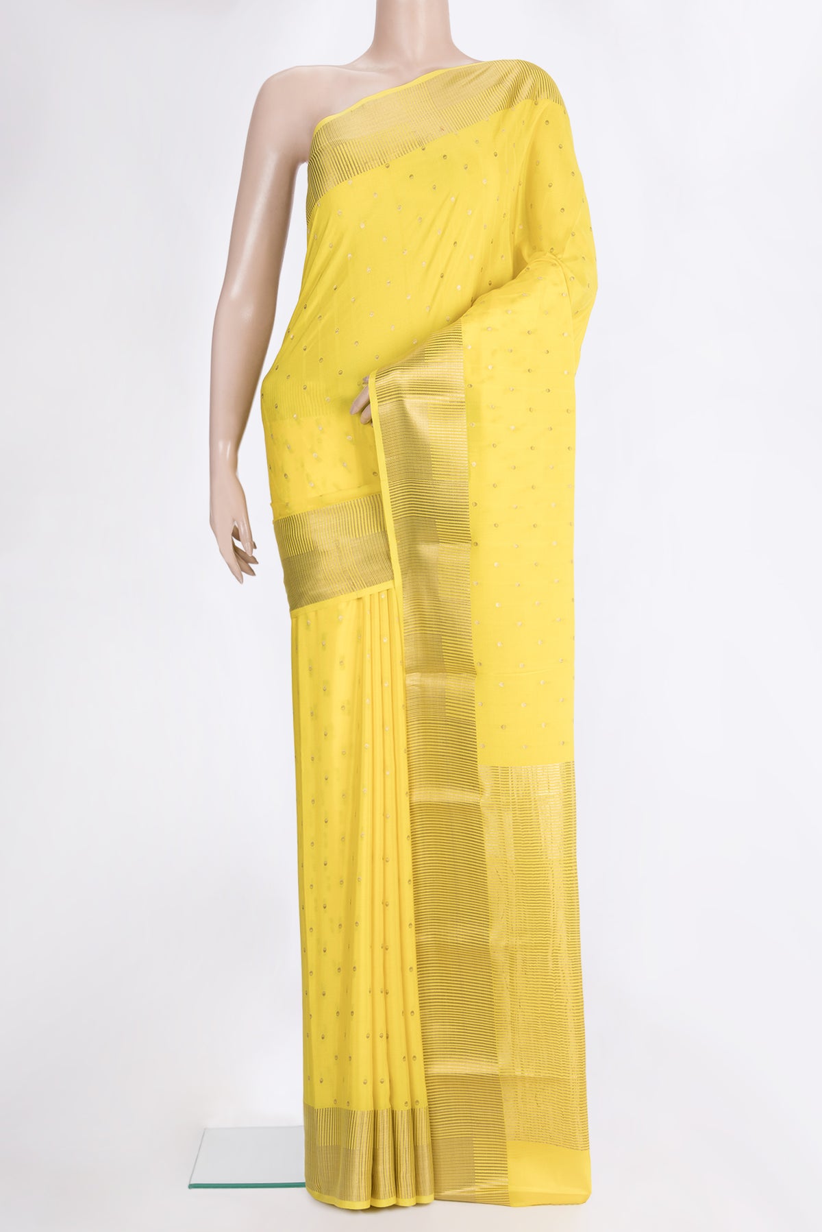 Lemon Yellow Mysore Crepe Saree with Zari Butta on the body and Zari Border.  displayed on a mannequin