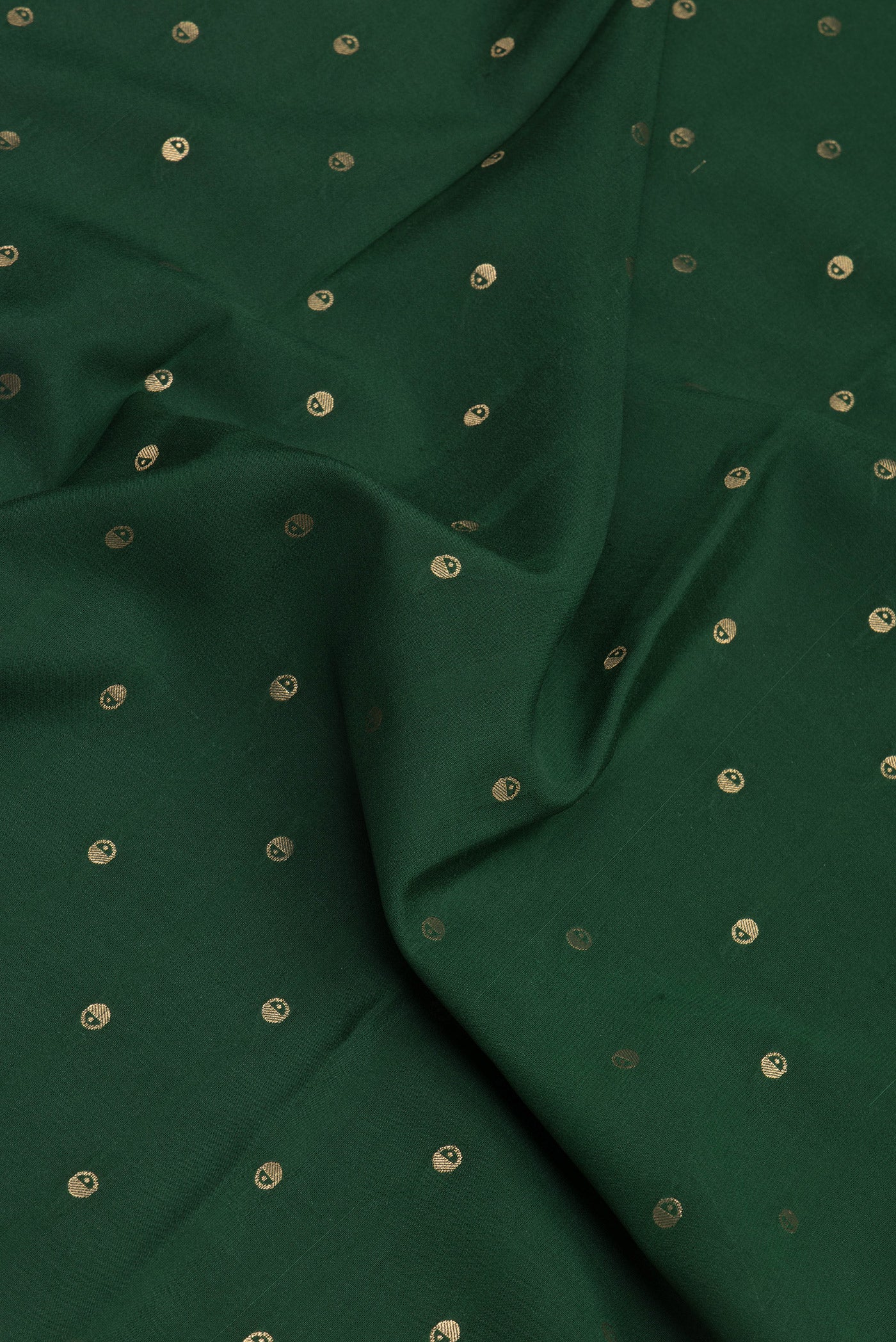Close up of Bottle Green Mysore Silk Saree with Zari Butta on the body and Zari Border.  displaying folds