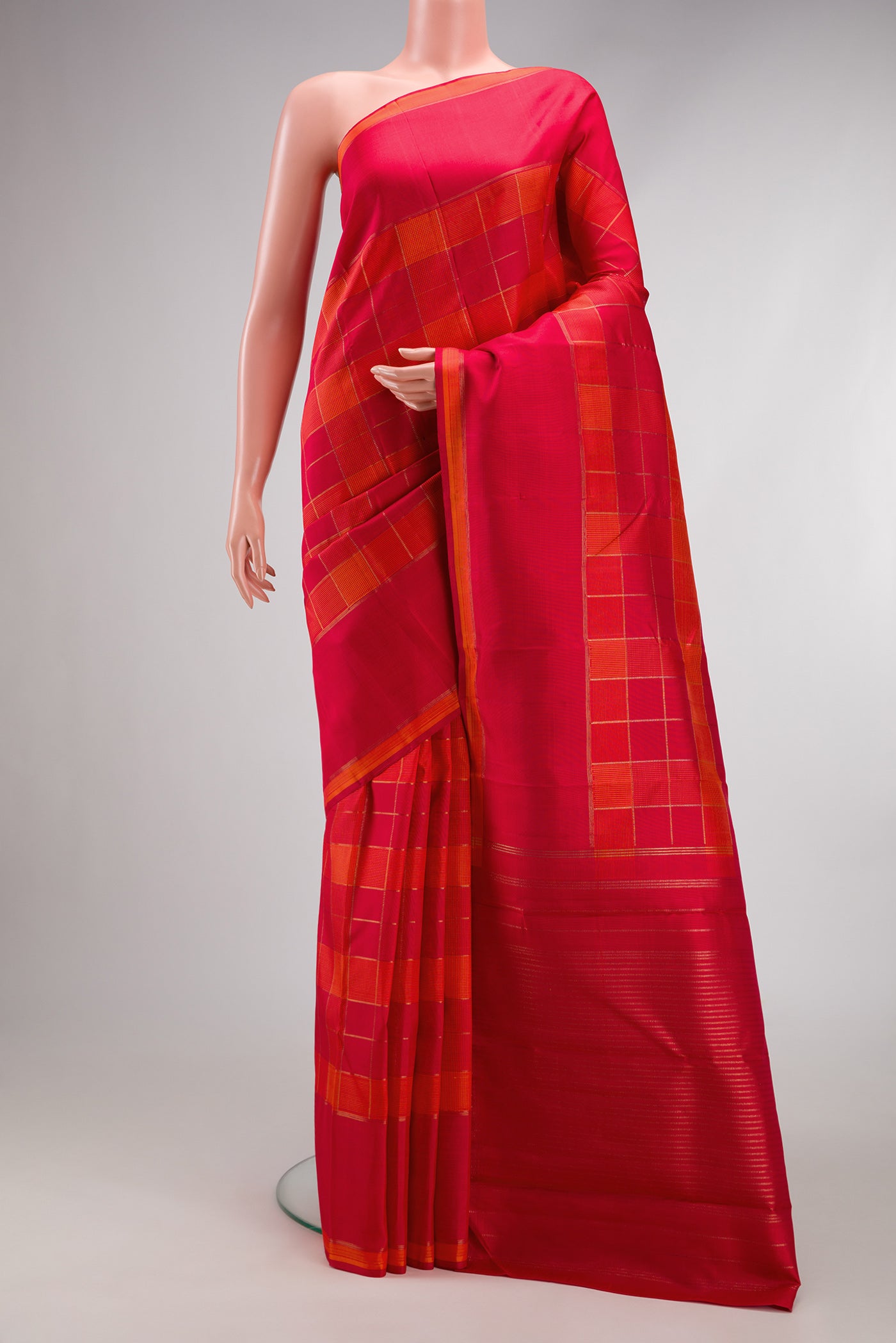 Pure Silk Pure Zari Orange and Dark Pink Color Kanchipuram Saree with Checked design on the body and Plain Border.  displayed on a mannequin