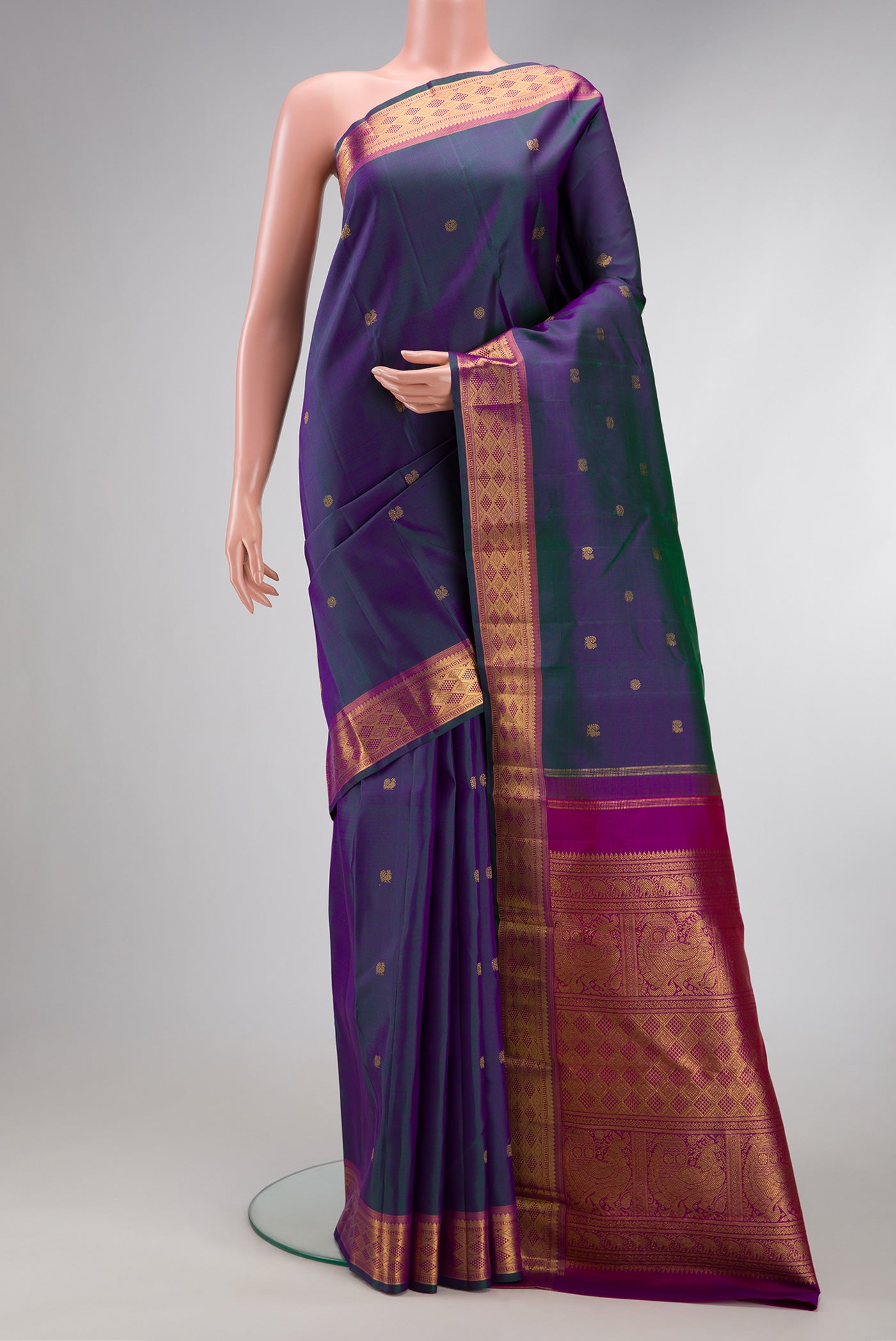 Peacock Blue Dual Tone Kanchipuram Silk Saree with Zari Butta on the body and Zari Border.  displayed on a mannequin