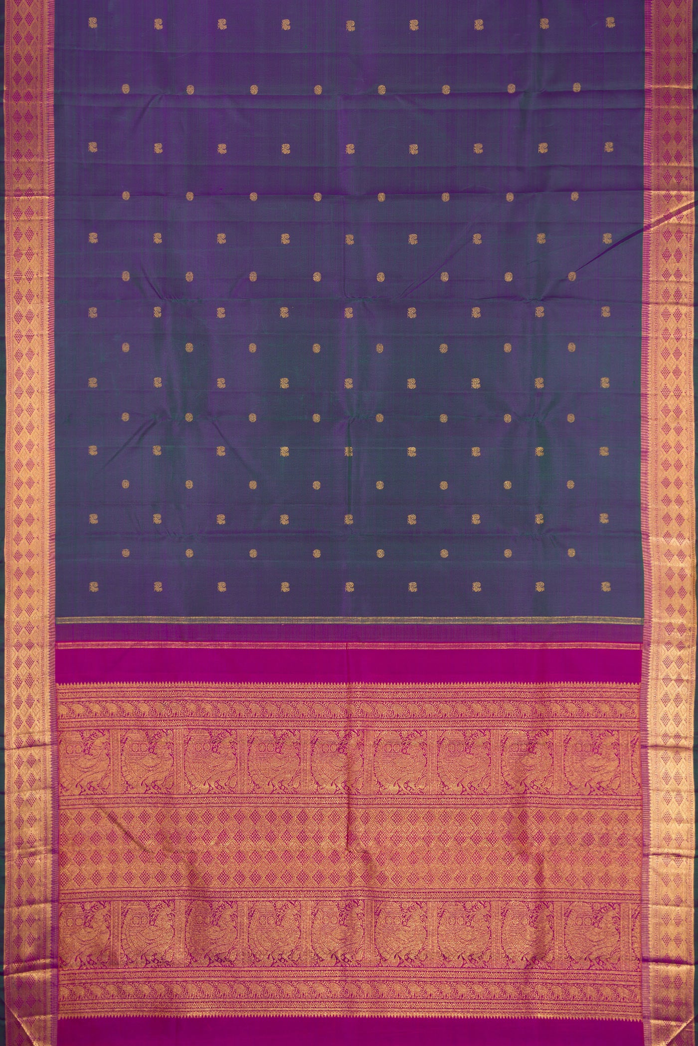 Flat view of Peacock Blue Dual Tone Kanchipuram Silk Saree with Zari Butta on the body and Zari Border. 