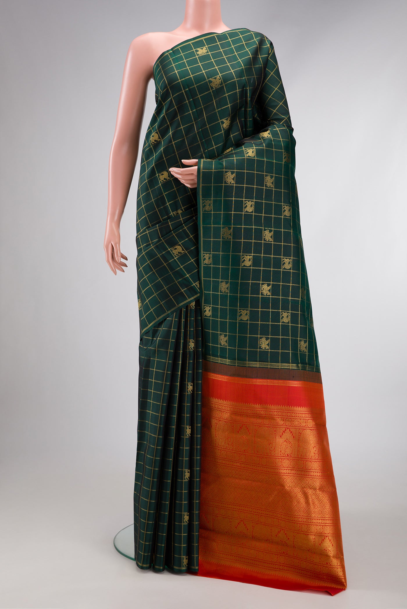 Pure Silk Pure Zari Bottle Green Dual Tone Kanjivaram Saree with Checked design on the body and Thin Zari Line.  displayed on a mannequin