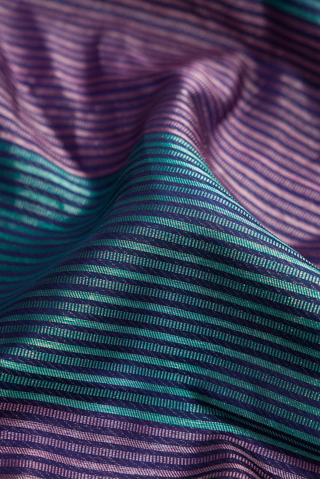 Close up of Pure Silk Pure Zari Navy Blue Dual Tone Kanjivaram Saree with Jacquard design on the body and Thread Border.  displaying folds