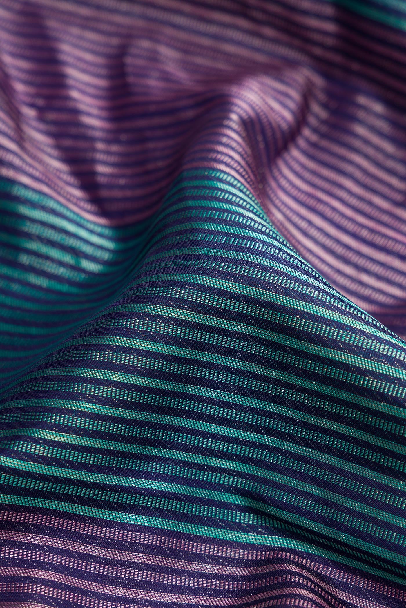 Close up of Pure Silk Pure Zari Navy Blue Dual Tone Kanjivaram Saree with Jacquard design on the body and Thread Border.  displaying folds