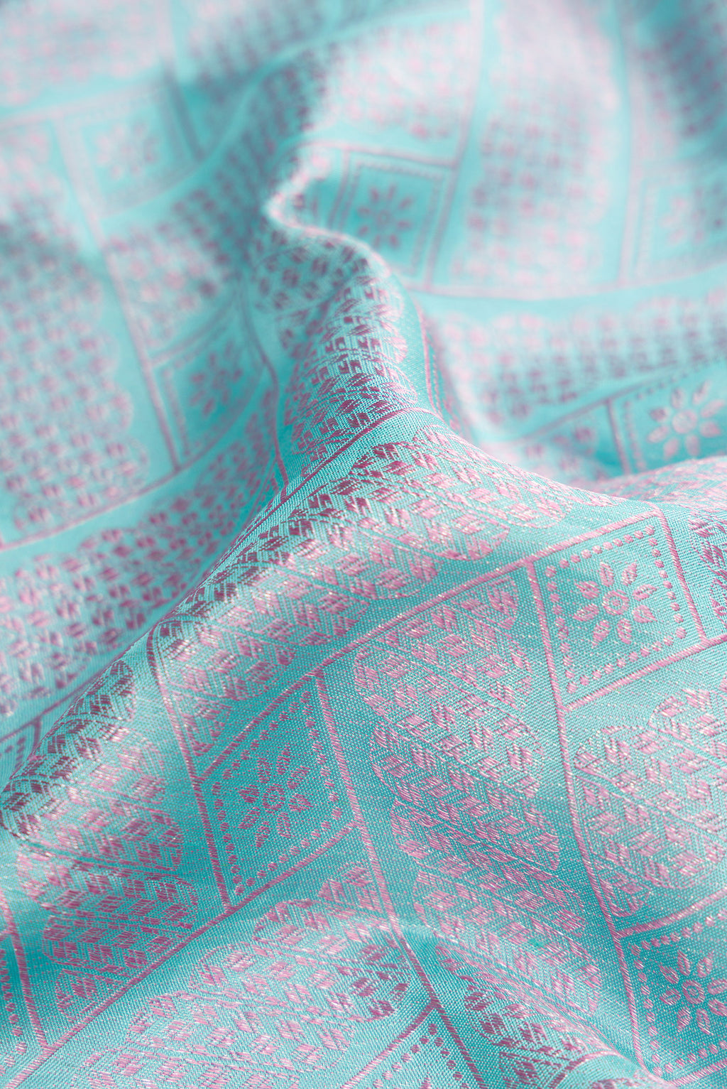 Close up of Light Blue Dual Tone Kanjivaram Silk Saree with Jacquard design on the body and Fancy Border.  displaying folds