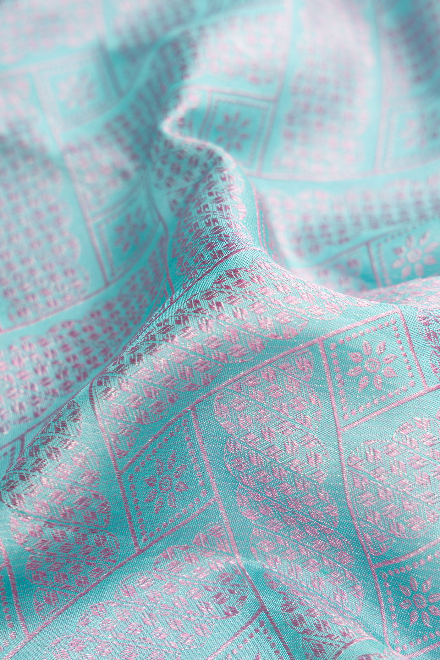 Close up of Light Blue Dual Tone Kanjivaram Silk Saree with Jacquard design on the body and Fancy Border.  displaying folds