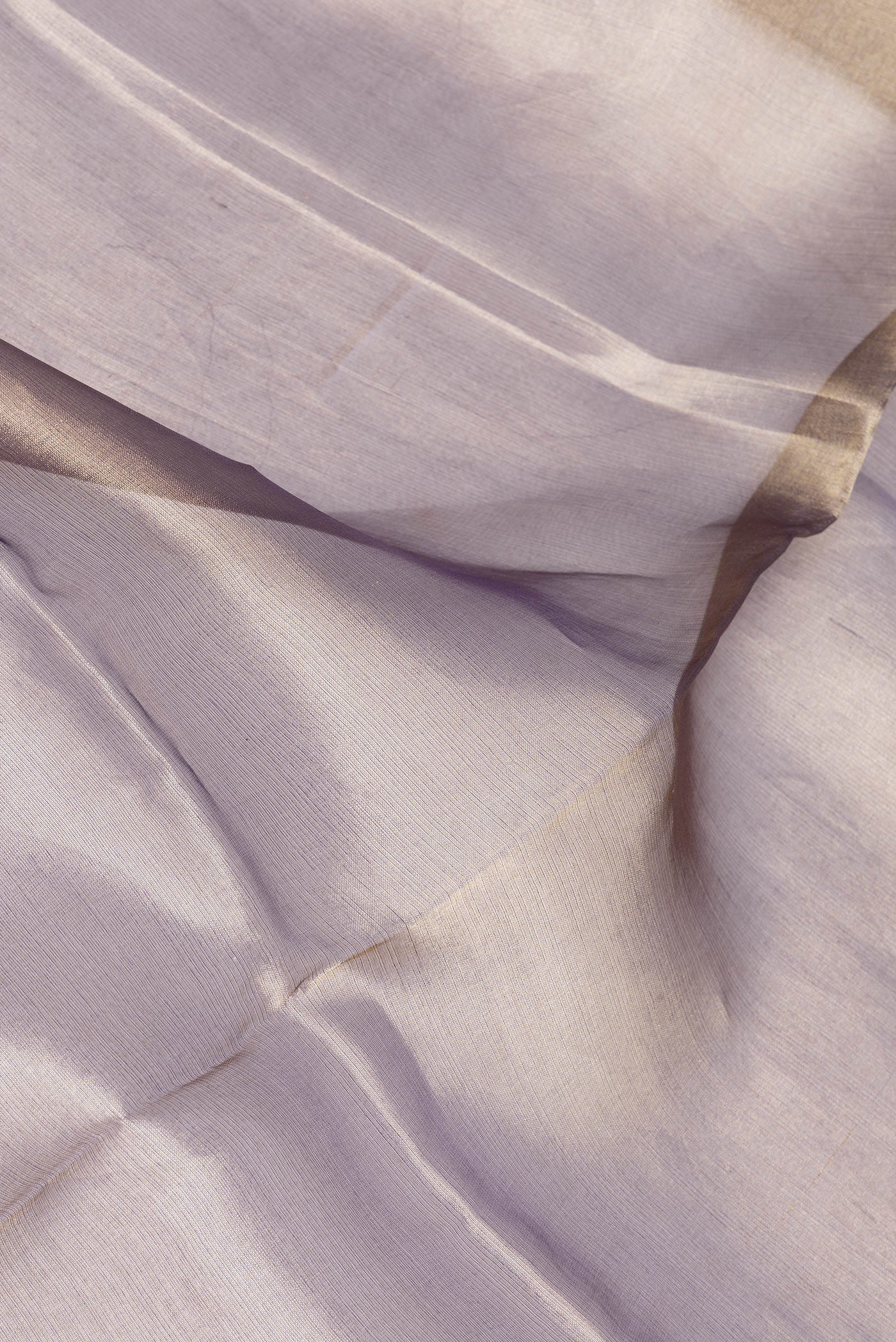 Close up of Lavender Dual Tone Organza Silk Saree with Plain Body and Fancy Border.  displaying folds