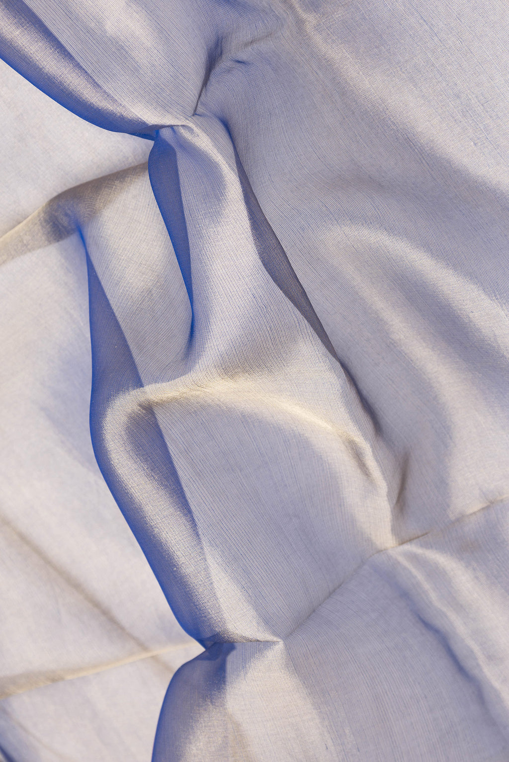 Close up of Navy Blue Dual Tone Organza Silk Saree with Plain Body and Fancy Border.  displaying folds