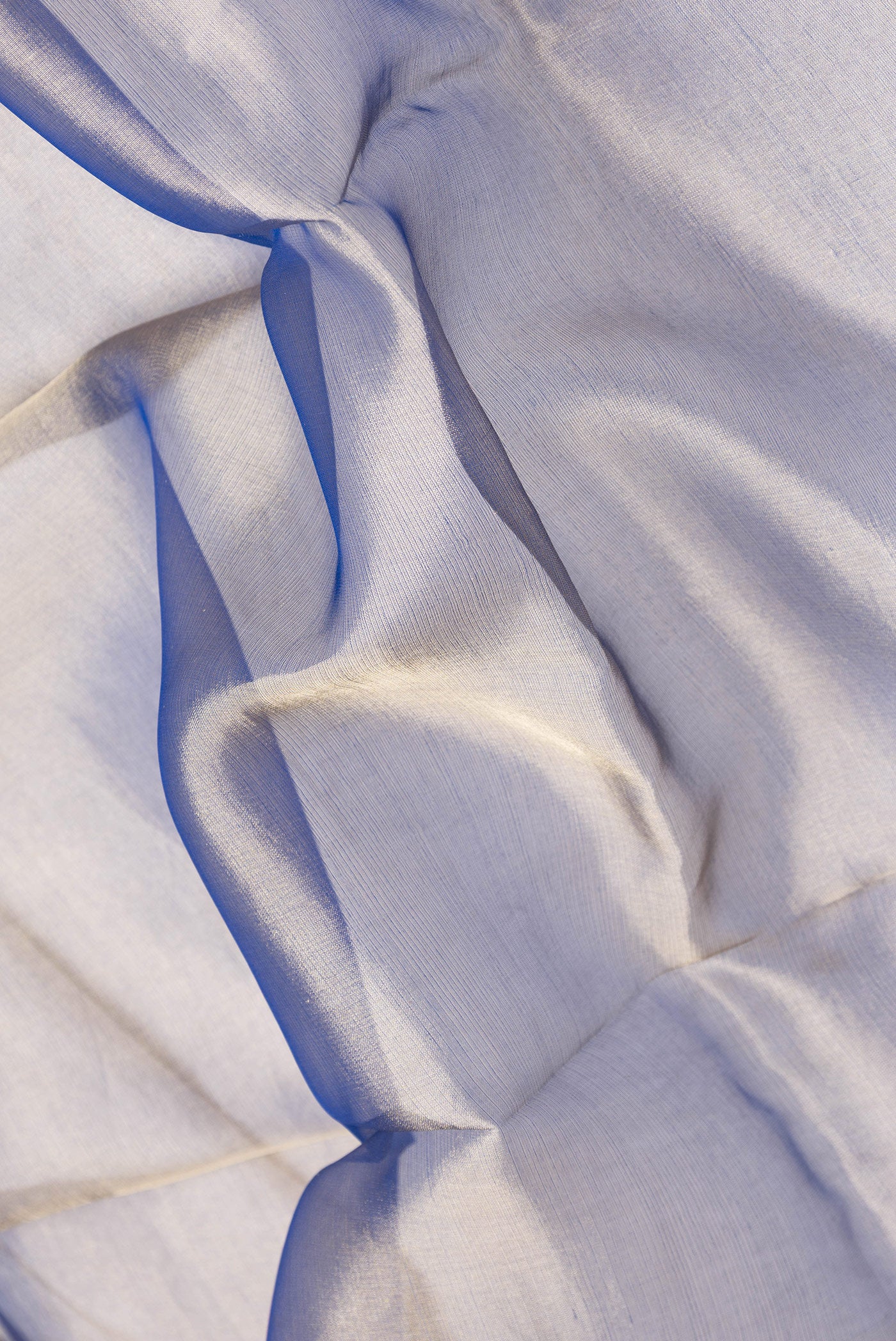 Close up of Navy Blue Dual Tone Organza Silk Saree with Plain Body and Fancy Border.  displaying folds