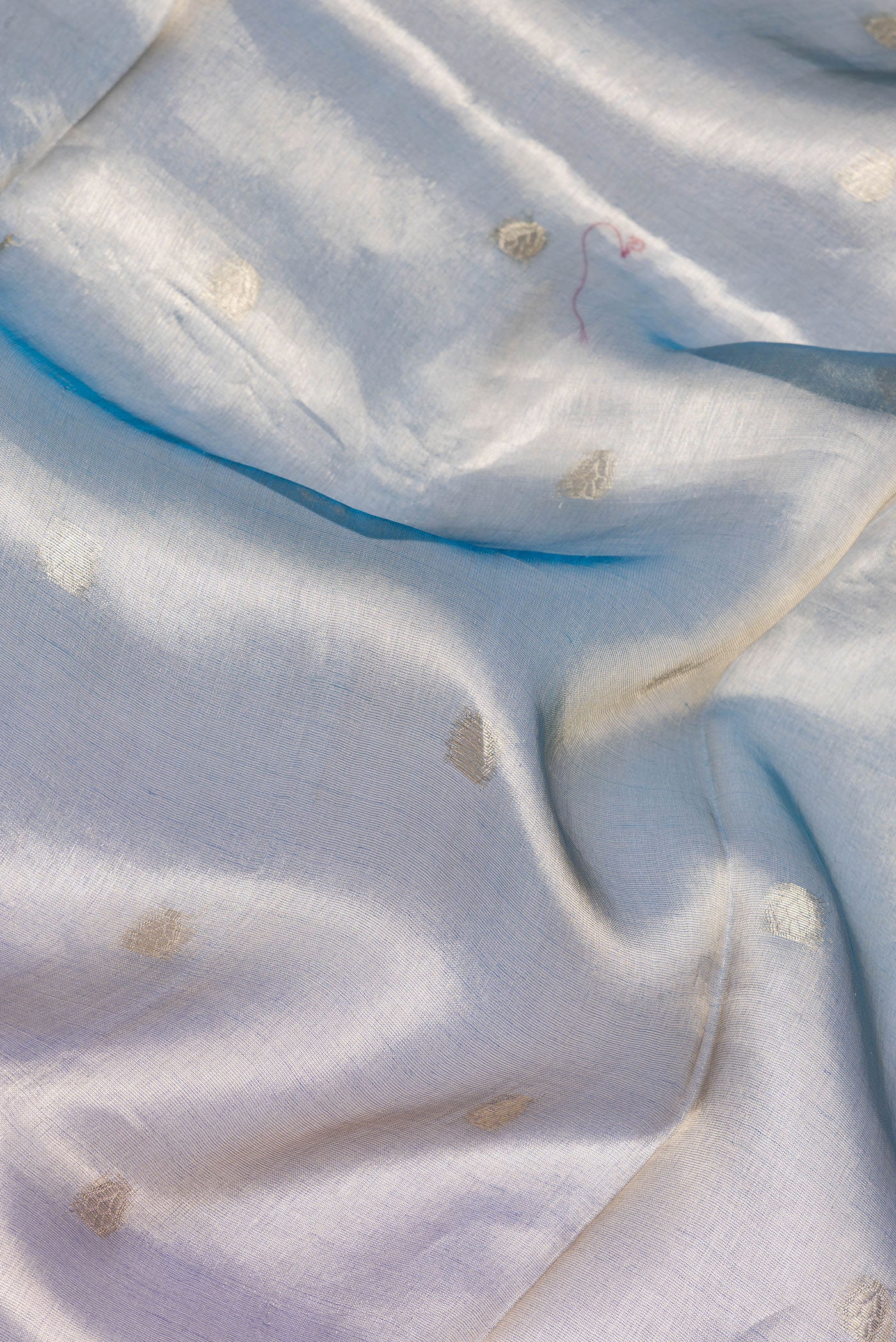 Close up of Green and Purple Color Organza Silk Saree with Zari Butta on the body and Zari Border.  displaying folds