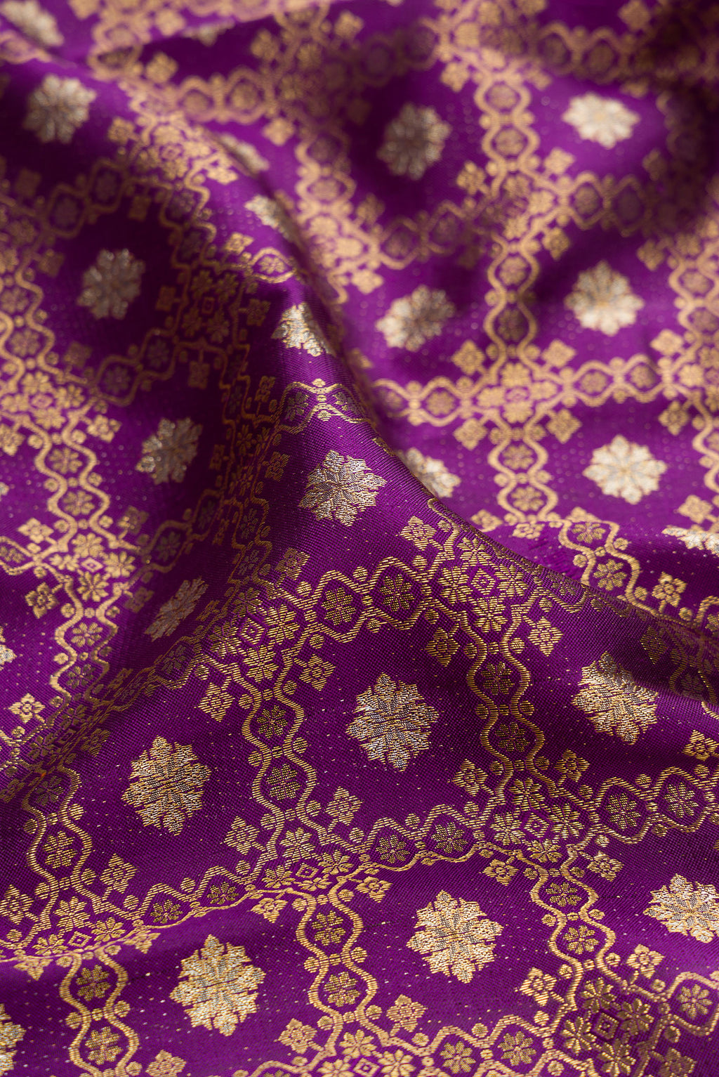 Close up of Purple Kanchipuram Silk Saree with Zari Brocade on the body and Zari Border.  displaying folds