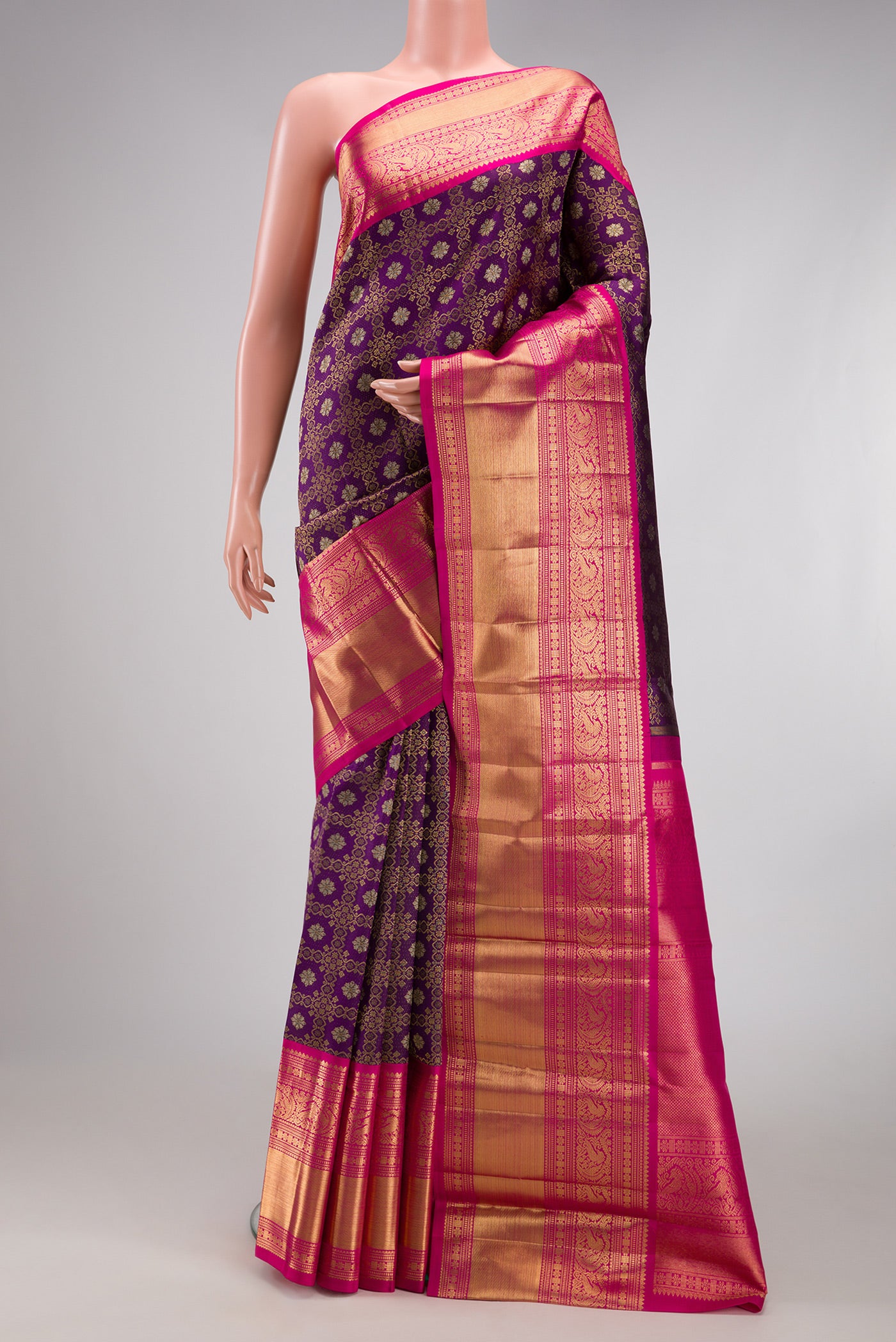 Purple Kanchipuram Silk Saree with Zari Brocade on the body and Zari Border.  displayed on a mannequin