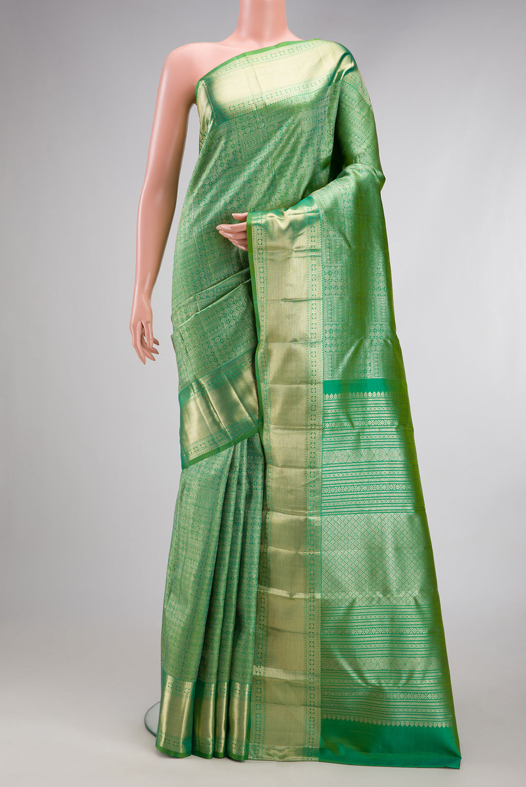 Green Kanchipuram Silk Saree with Zari Brocade on the body and Zari Border.  displayed on a mannequin