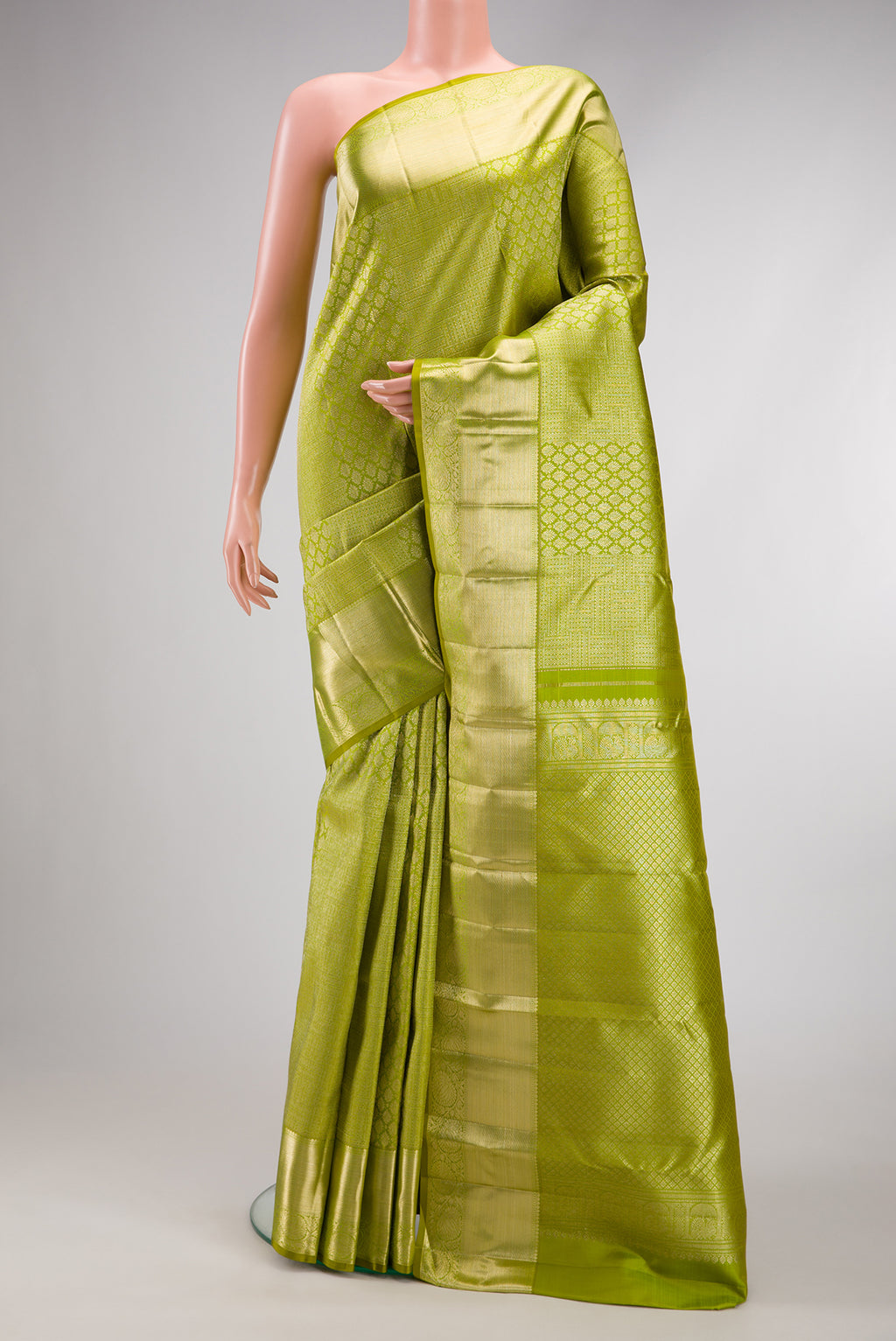 Parrot Green Dual Tone Kanchipuram Silk Saree with Zari Brocade on the body and Zari Border.  displayed on a mannequin