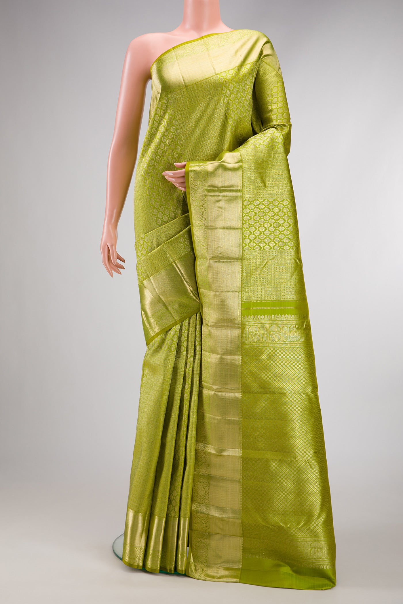 Parrot Green Dual Tone Kanchipuram Silk Saree with Zari Brocade on the body and Zari Border.  displayed on a mannequin