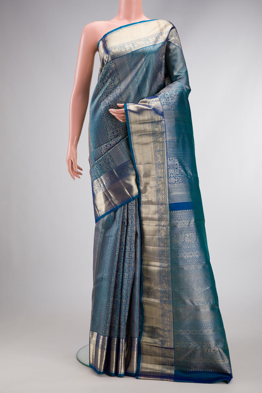 Peacock Blue Dual Tone Kanchipuram Silk Saree with Zari Brocade on the body and Zari Border.  displayed on a mannequin