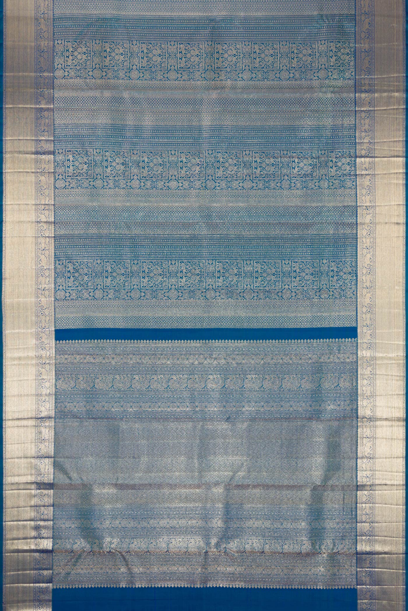 Flat view of Peacock Blue Dual Tone Kanchipuram Silk Saree with Zari Brocade on the body and Zari Border. 