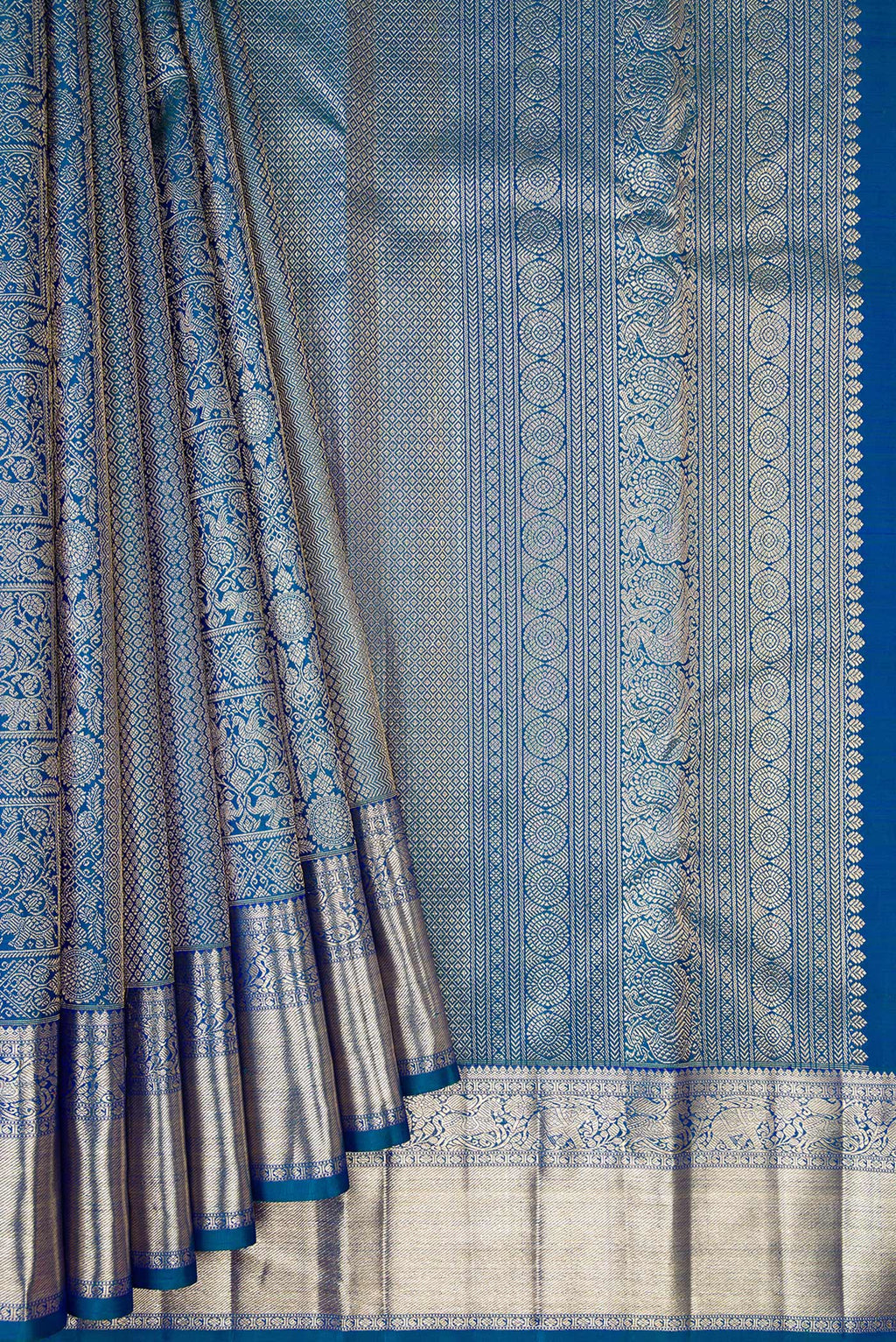 Pleats and pallu of Peacock Blue Dual Tone Kanchipuram Silk Saree with Zari Brocade on the body and Zari Border. 