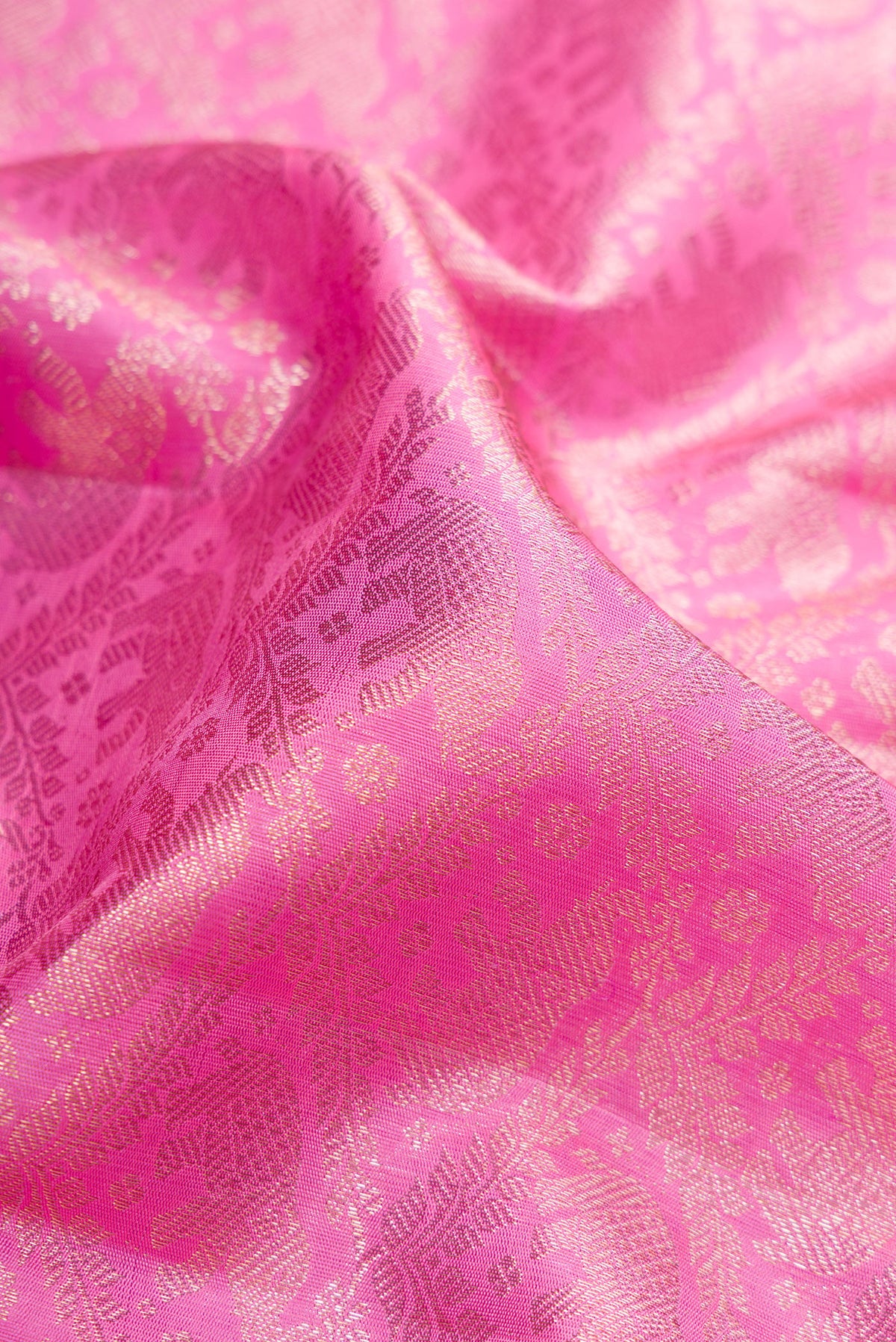 Close up of Pink Dual Tone Kanchipuram Silk Saree with Zari Brocade on the body and Zari Border.  displaying folds