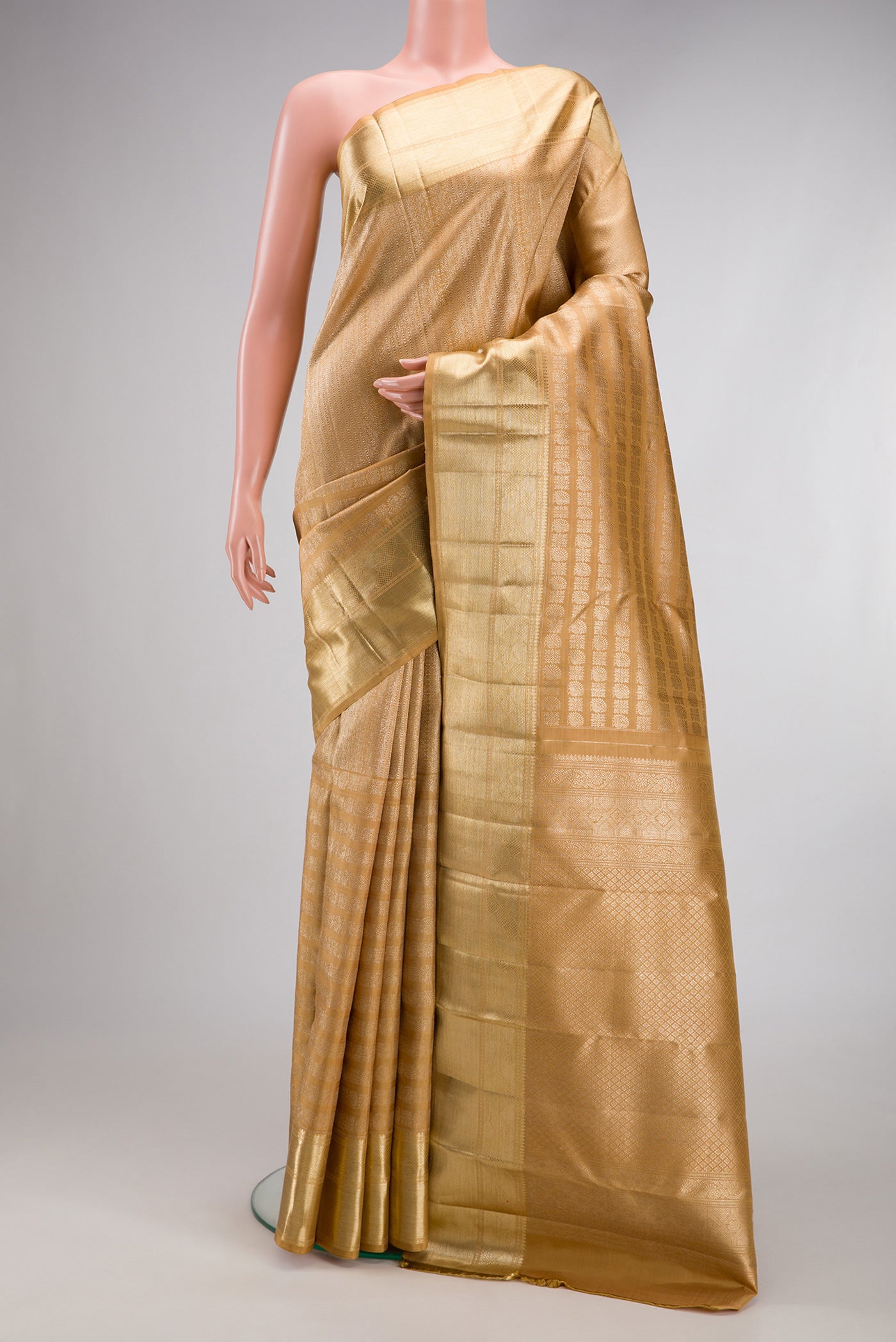 Gold Kanchipuram Silk Saree with Zari Brocade on the body and Zari Border.  displayed on a mannequin