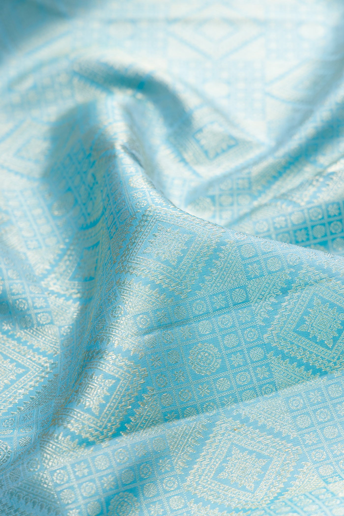 Close up of Sky Blue Kanchipuram Silk Saree with Zari Brocade on the body and Zari Border.  displaying folds