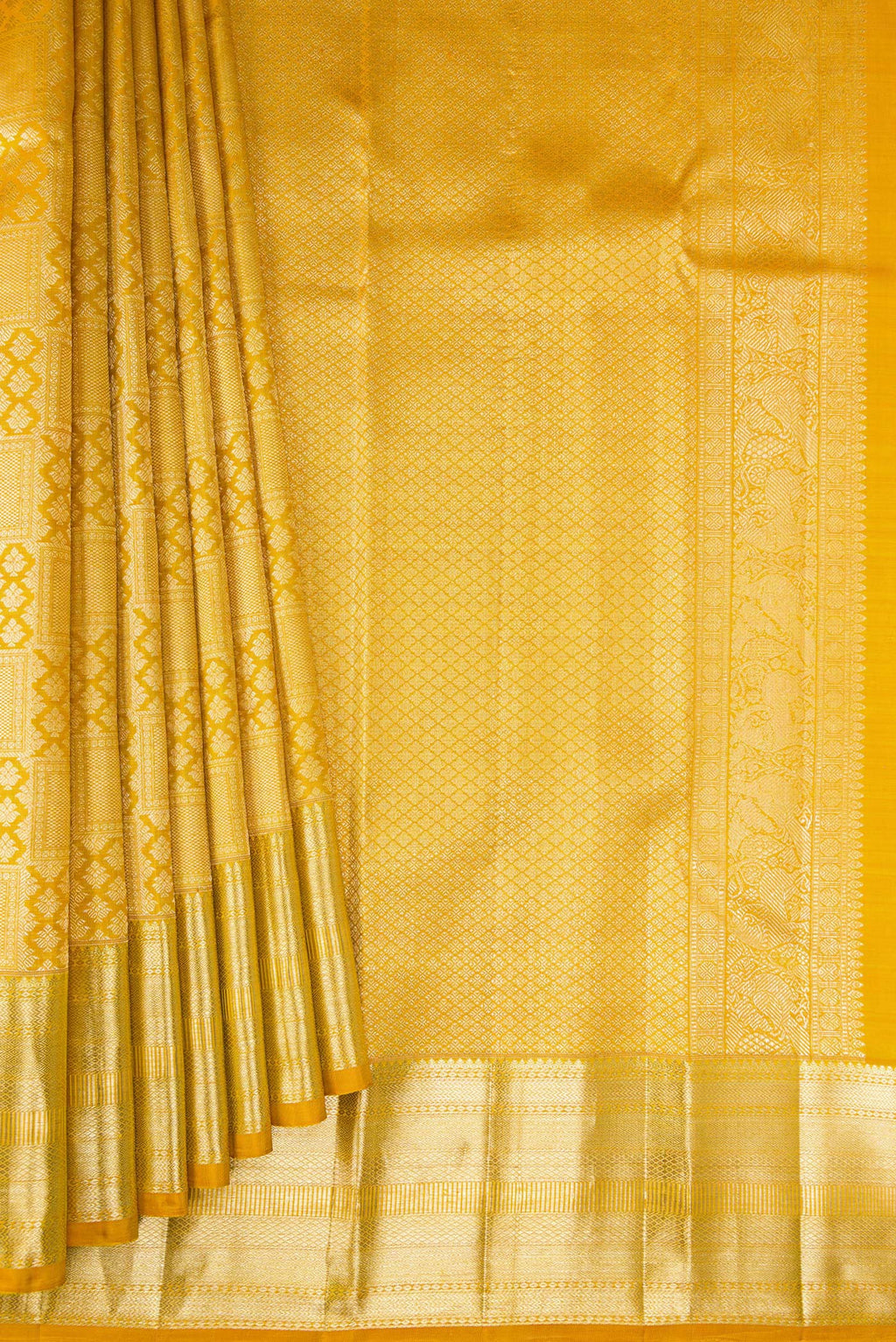Pleats and pallu of Mustard Kanchipuram Silk Saree with Zari Brocade on the body and Zari Border. 