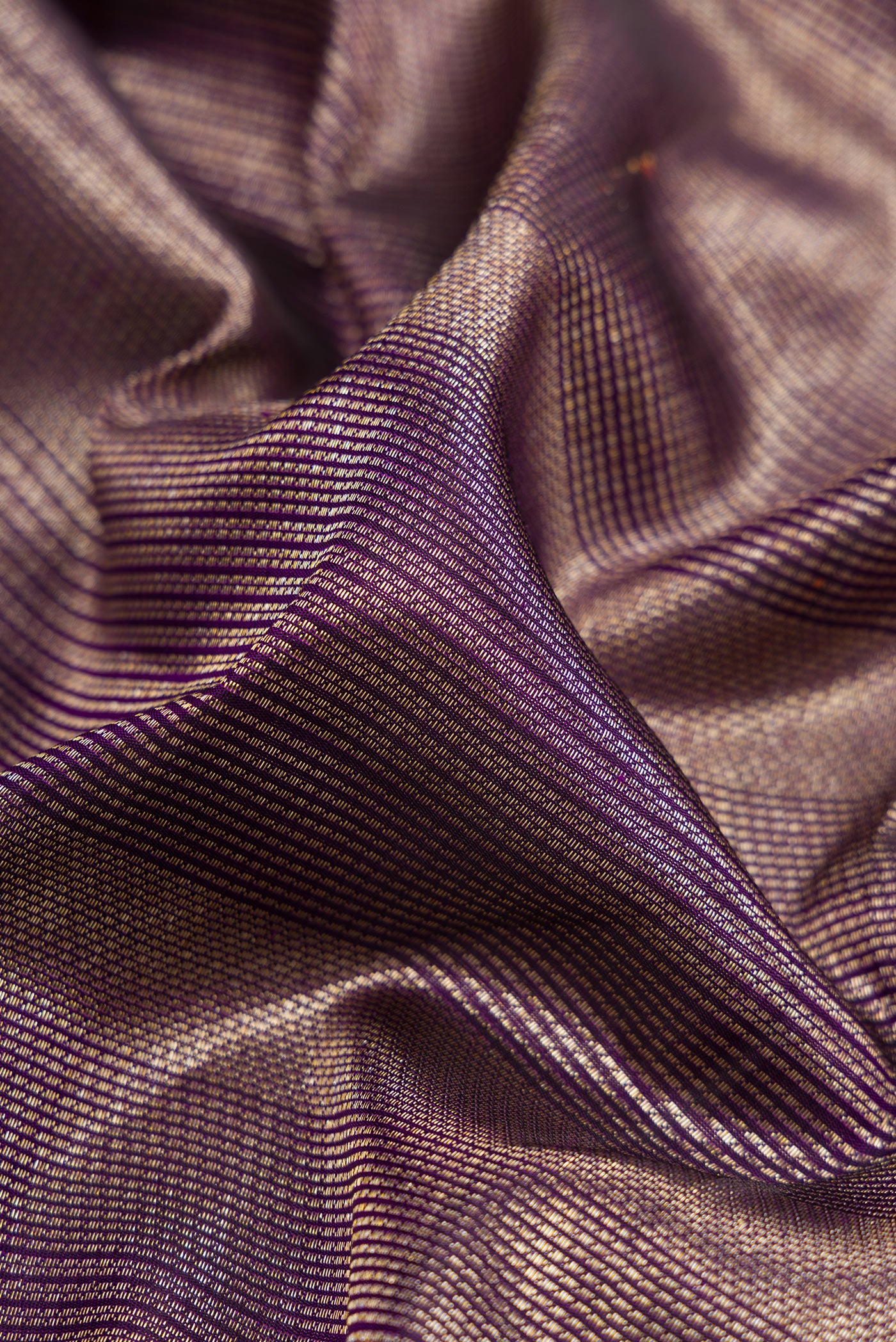 Close up of Violet Dual Tone Kanchipuram Silk Saree with Zari Brocade on the body and Zari Border.  displaying folds