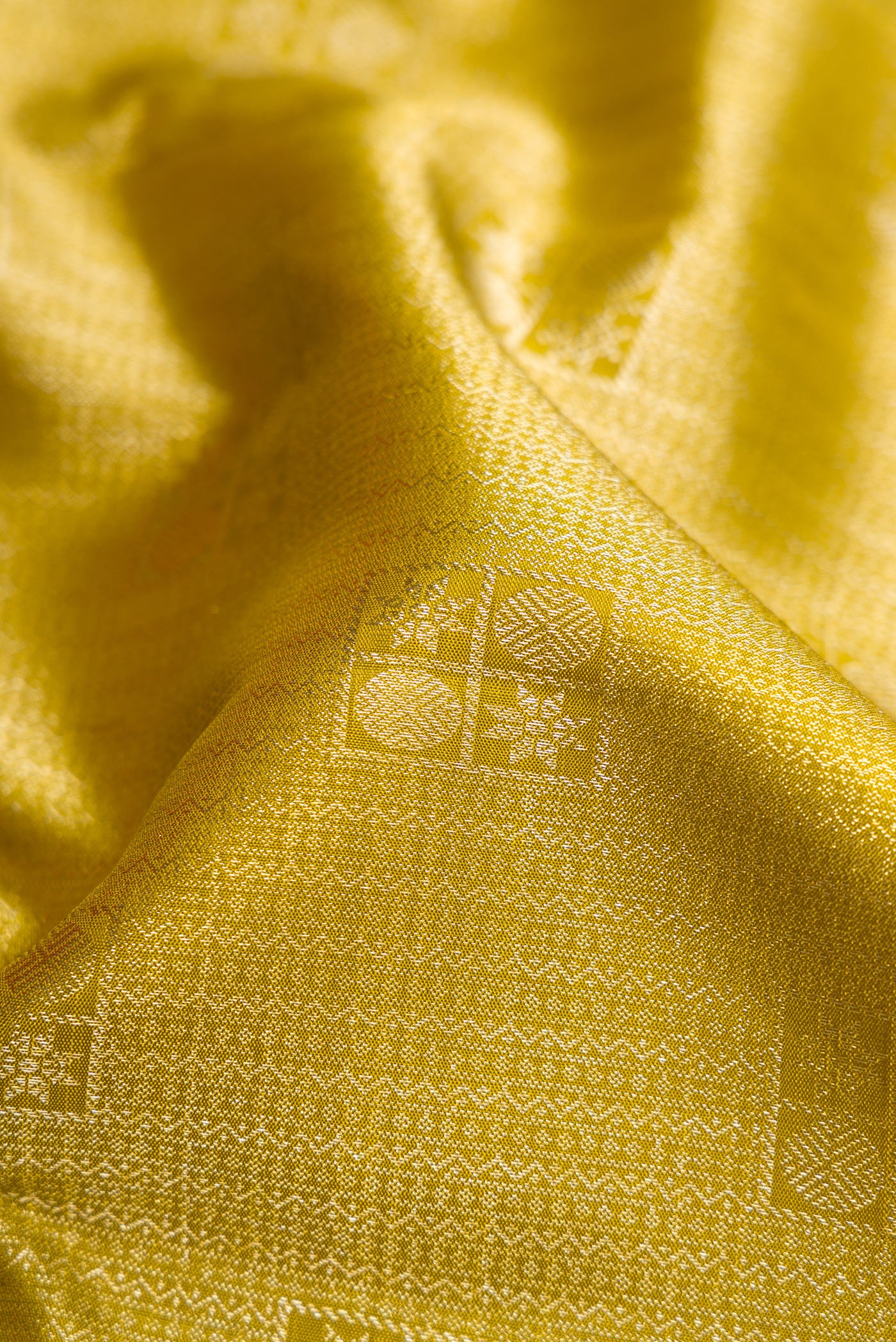 Close up of Mehandi Green Dual Tone Kanchipuram Silk Saree with Zari Brocade on the body and Zari Border.  displaying folds