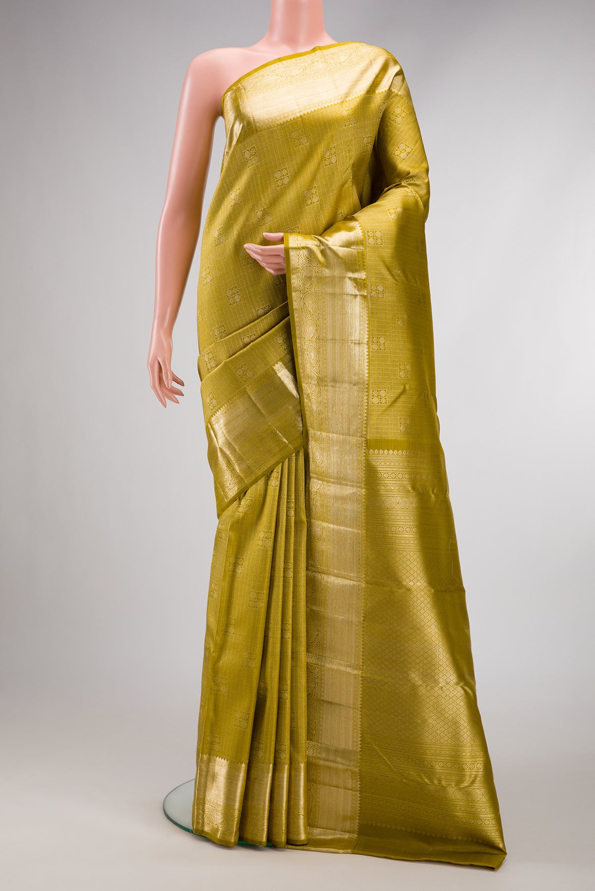 Mehandi Green Dual Tone Kanchipuram Silk Saree with Zari Brocade on the body and Zari Border.  displayed on a mannequin