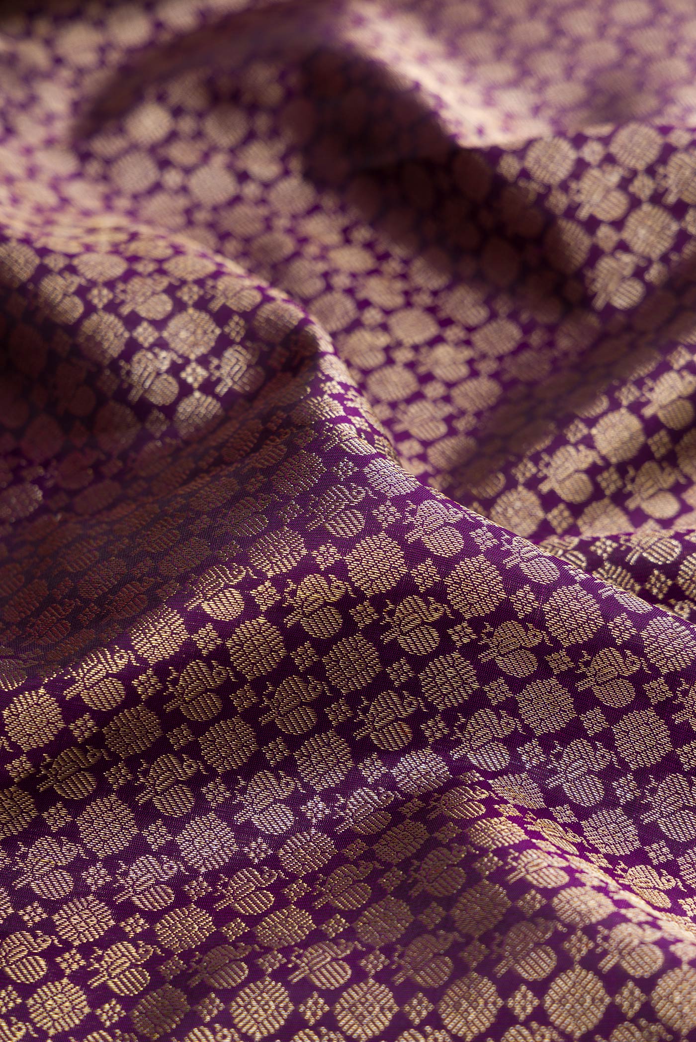 Close up of Purple Kanchipuram Silk Saree with Zari Brocade on the body and Fancy Border.  displaying folds