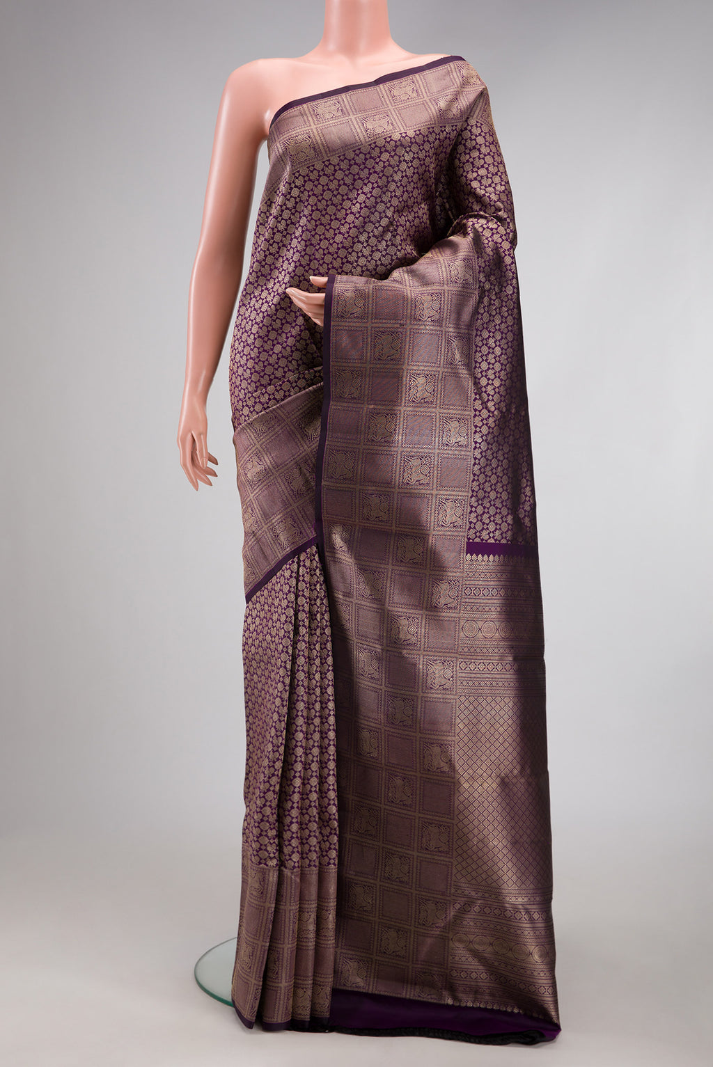 Purple Kanchipuram Silk Saree with Zari Brocade on the body and Fancy Border.  displayed on a mannequin