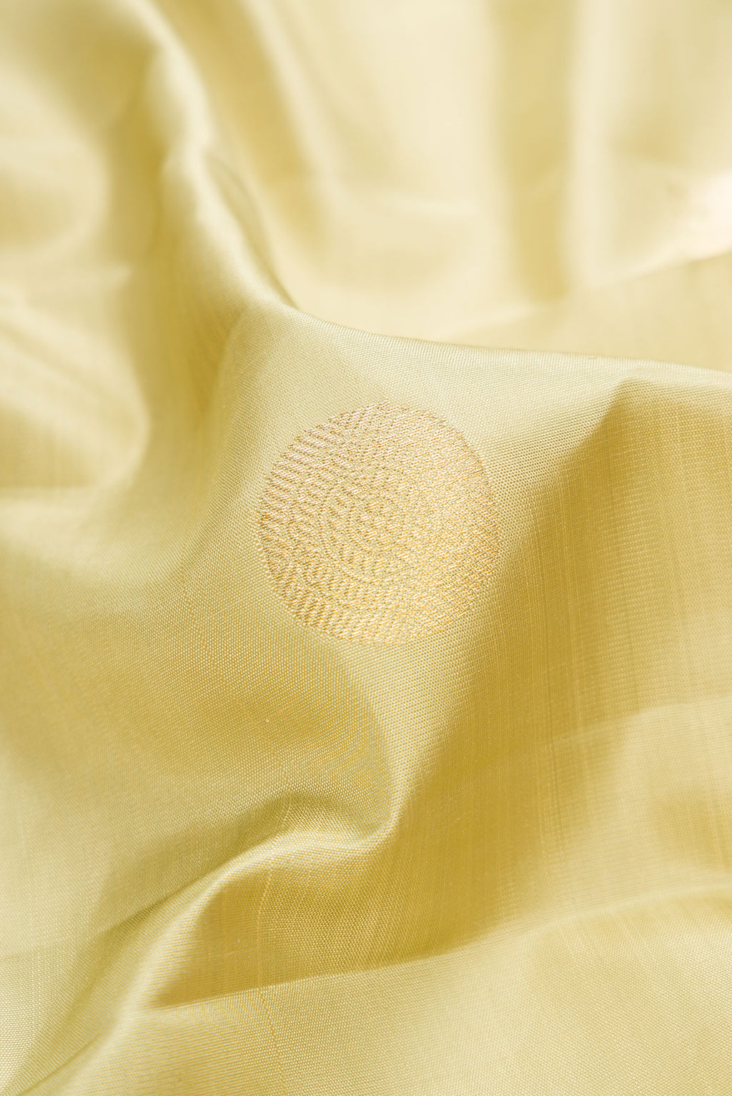 Close up of Pista Green Dual Tone Kanchipuram Silk Saree with Zari Butta on the body and Zari Border.  displaying folds