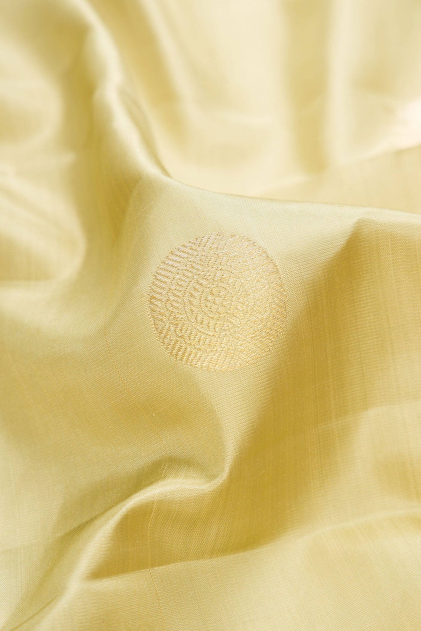 Close up of Pista Green Dual Tone Kanchipuram Silk Saree with Zari Butta on the body and Zari Border.  displaying folds