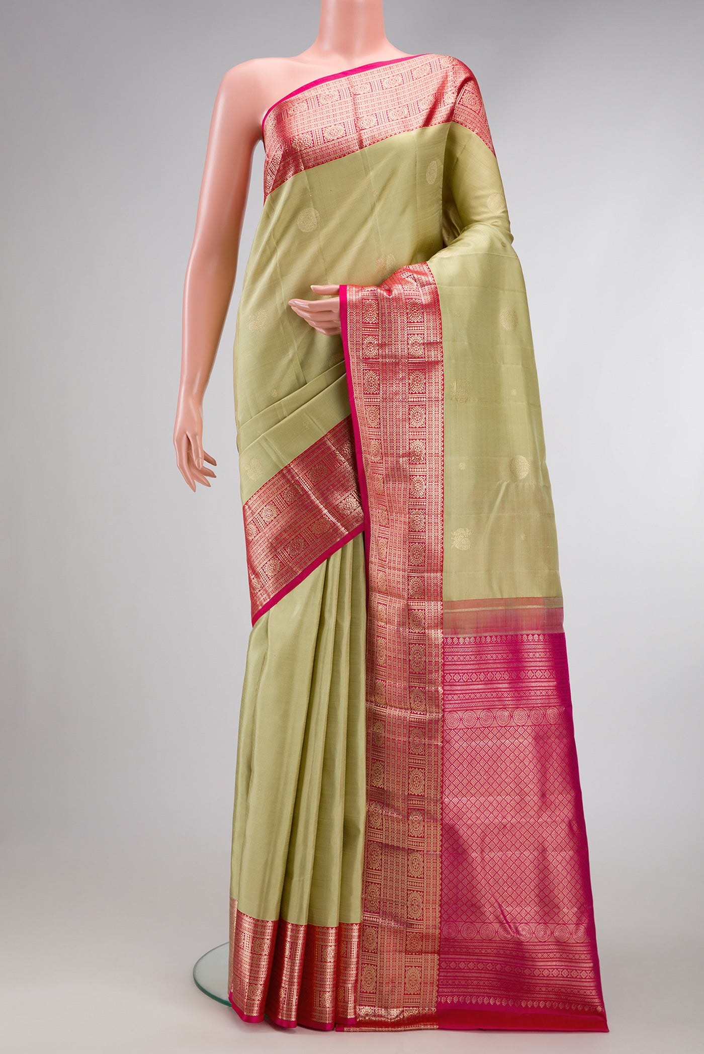 Pista Green Dual Tone Kanchipuram Silk Saree with Zari Butta on the body and Zari Border.  displayed on a mannequin