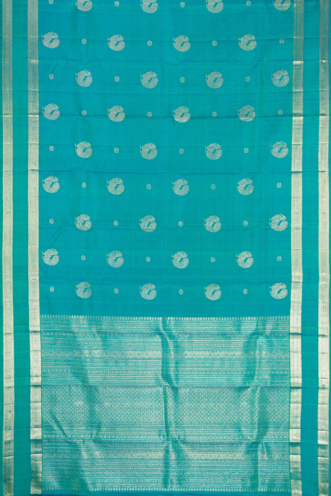 Flat view of Peacock Blue Dual Tone Kanjivaram Silk Saree with Zari Butta on the body and Zari Border. 