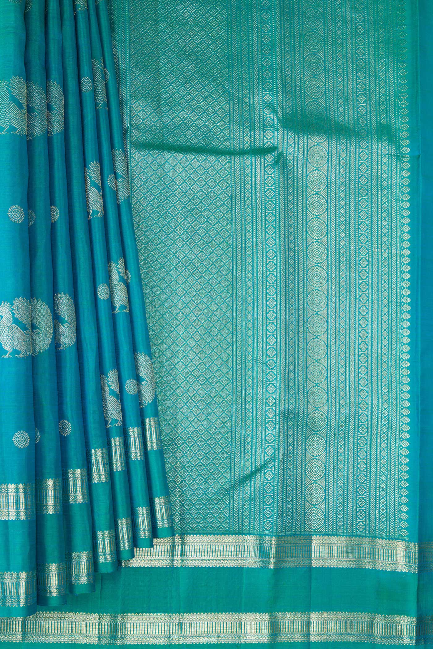 Pleats and pallu of Peacock Blue Dual Tone Kanjivaram Silk Saree with Zari Butta on the body and Zari Border. 