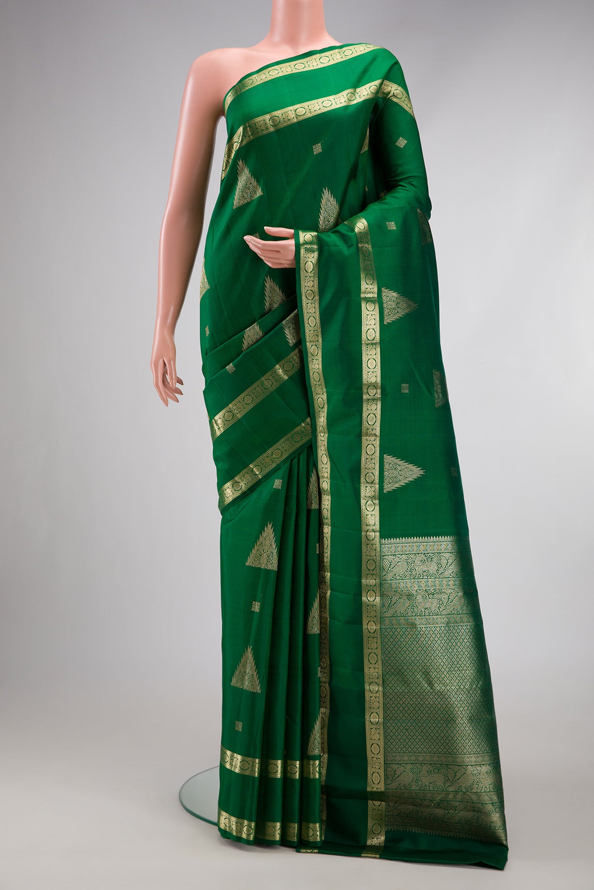 Bottle Green Kanjivaram Silk Saree with Zari Butta on the body and Zari Border.  displayed on a mannequin