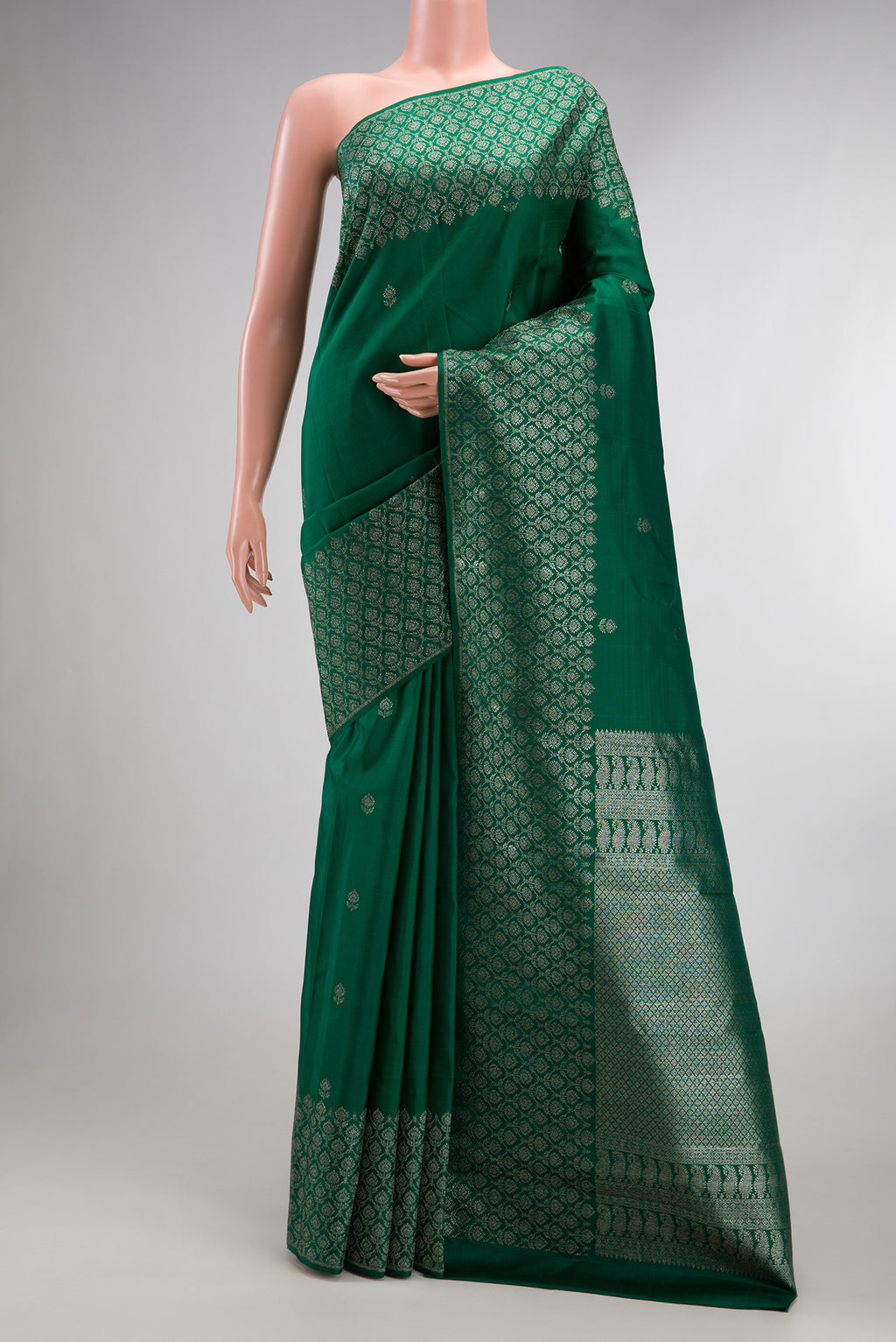 Pure Silk Bottle Green Kanjivaram Saree with Zari Butta on the body and Fancy Border.  displayed on a mannequin