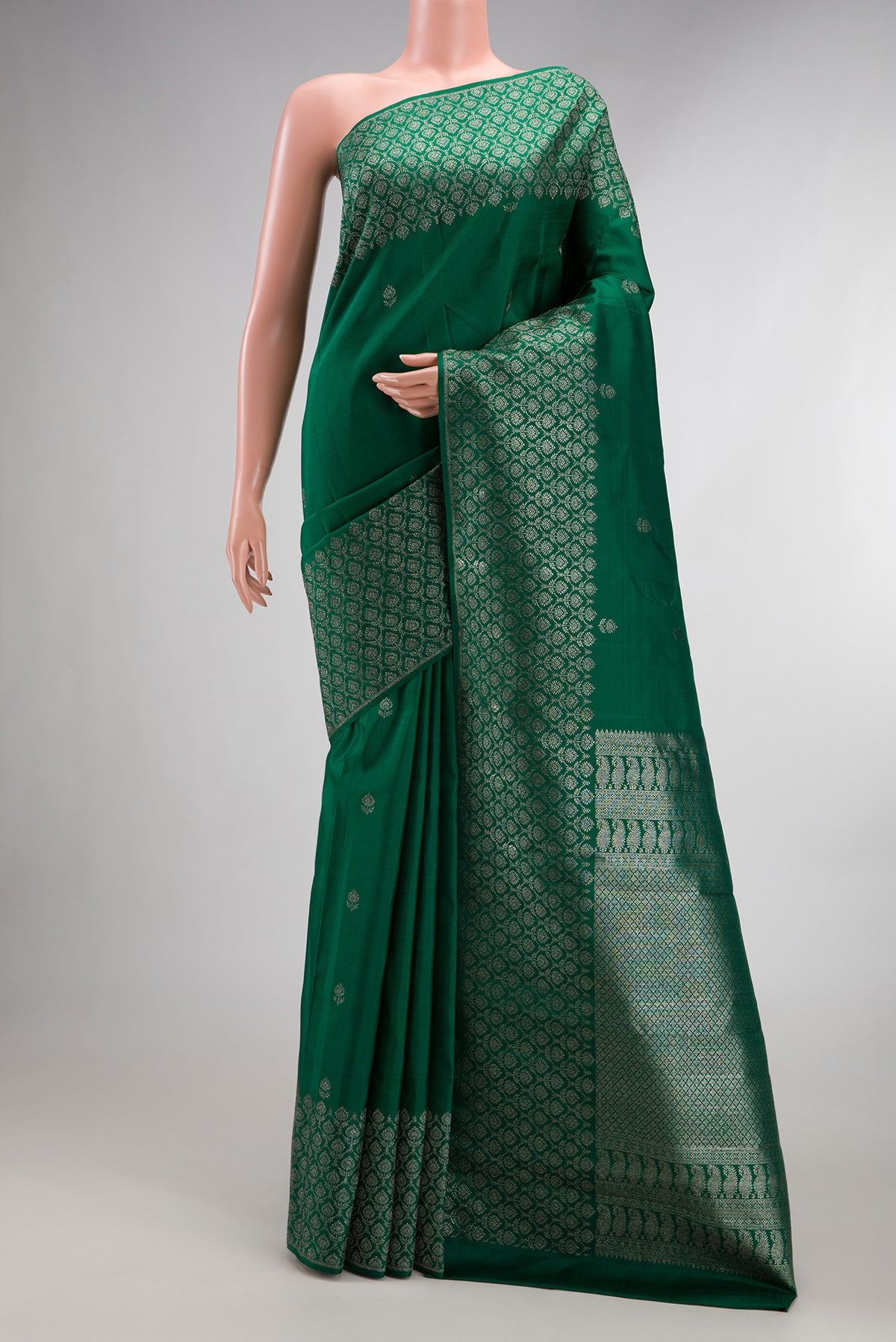Pure Silk Bottle Green Kanjivaram Saree with Zari Butta on the body and Fancy Border.  displayed on a mannequin